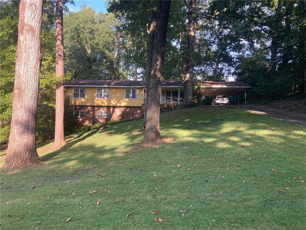 This is one one of the best and quietest areas of Leafmore just 2 blocks from Leafmore Club Swim, Tennis, Club House, sand volleyball & play field(MEMBERSHIP REQUIRED). Dreamy 100' x 200" lot that sits above street level with a private backyard + a grade that gently slopes away from the home front and back. PERFECT DAYLIGHT BASEMENT LOT WITH WINDOWS ON 3 SIDES. Comparable NEW HOME COMPS at $1.8M+ and a recent neighborhood BUILD OVER build over comp at $1.6M. Located a short walk to the shops and restaurants of Oak Grove and the South Peachtree Creek Trail System(access to Mason Mill park, Dog park, Medlock Park, Avis G Williams Library and Candler lake/Emory Campus). HOME IS BEING SOLD STRICLTY CASH AND AS IS. POWER CABLE WAS HIT BY A TREE LIMB AND NO ULITIES WILL BE TURNED ON. THIS HOME NEEDS A COMPLETE GUT JOB RENVOATION OR IT MAY BE A CANDIDATE FOR A NEW BUILD. BUYER WILL BE RESPONSIBLE FOR EMPTYING THE HOME. LISTING AGENT WILL ATTEND ALL SHOWINNGS. MOLD IS PRESENT, SO ANYONEE ENTERING MUST SIGN A HOLD HARMLESS AGREEMENTS. NO OFFERS WILL BE CONSIDERED UNTIL MONDAY (9/15). Subject to the Leafmore/Dekalb Infill Housing Ordinance limiting the height of renovations/new construction to 28' above the present front door threshold.