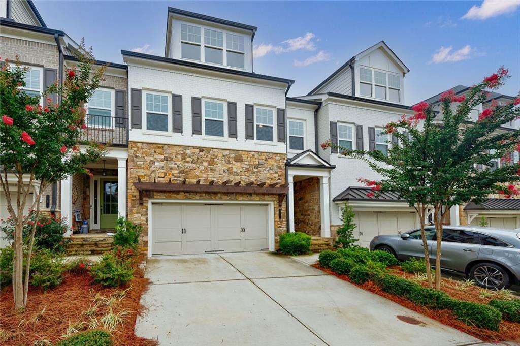 From the moment you step into this custom-built townhome, you’ll appreciate the thoughtful design and high-end finishes throughout. Wide plank, hand-scraped hardwoods set the tone, while the chef’s kitchen steals the show with quartz countertops, double wall ovens, a sleek microwave drawer, and tall 42” upper cabinets topped with elegant glass-front display cabinets for added storage and style.
Very desirable in the community, this home is one of the very few in the neighborhood with a basement. Featuring 10 foot ceilings on main, the Concord floor plan offers an open, sun-drenched main level with a seamless flow to the private backyard and elevated deck—perfect for morning coffee or evening entertaining. The separate dining room and adjoining family room create the perfect setting for hosting family and friends, while the oversized island serves as the heart of the home—ideal for meal prep, casual dining, or just gathering around with good company.
Storage is no afterthought here—every level offers generous closets, with custom shelving behind nearly every door. And yes, it’s elevator-ready.
Upstairs, you’ll find an expansive landing (think reading nook or homework station), along with a spacious primary suite that includes a cozy sitting room with an electric fireplace—ideal for Netflix marathons or your dream home office setup. The spa-inspired ensuite bath features dual vanities, a frameless glass shower with bench, and a soaking tub to unwind in style. The custom closet flows effortlessly into the connected laundry room—smart and convenient.
Two additional upstairs bedrooms and a full bath offer flexible space for guests, kids, or whatever life throws your way.
The lower level features a fourth bedroom, full bath, large family room, and bonus flex space—perfect for a gym, hobby room, or game night central.
Situated directly across from the expansive community green space, you will enjoy resort-style amenities including two pools, tennis and pickleball courts, dog parks, walking trails, a community garden, and a clubhouse that hosts everything from food trucks and wine tastings to fitness classes and live music on the green. Located in the sought-after gated community of Harlow, you're just minutes from Avalon, downtown Alpharetta, historic Roswell, and the Ameris Bank Amphitheatre.
Luxury, comfort, and connection—it’s all waiting for you at Harlow.