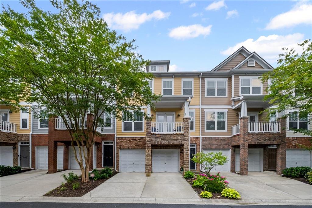 Welcome to this updated 3 bedroom townhome in the affordable Wyndham community. This spacious home features new luxury vinyl plank flooring throughout the main and second floors and new carpet in terrace level. You will love relaxing in the large fireside family room that is completely open to the kitchen and dining areas. The kitchen features plenty of cabinet space and overlooks the private backyard area. Upstairs you will find a beautiful primary bedroom suite, complete with walk-in closet and updated spa bath with new tile floors & tile shower + a huge guest bedroom suite with private bath. The walls were recently painted, the roof & water heater are all less than 4 years old + the air conditioning units have also been recently replaced. This is truly MOVE IN READY and located in the back of the community for a quiet living environment. This community is located just a few miles from GA400, Halcyon and the Windward Pkwy shopping district. Wyndham is zoned for the sought after Cambridge High School--Welcome Home!