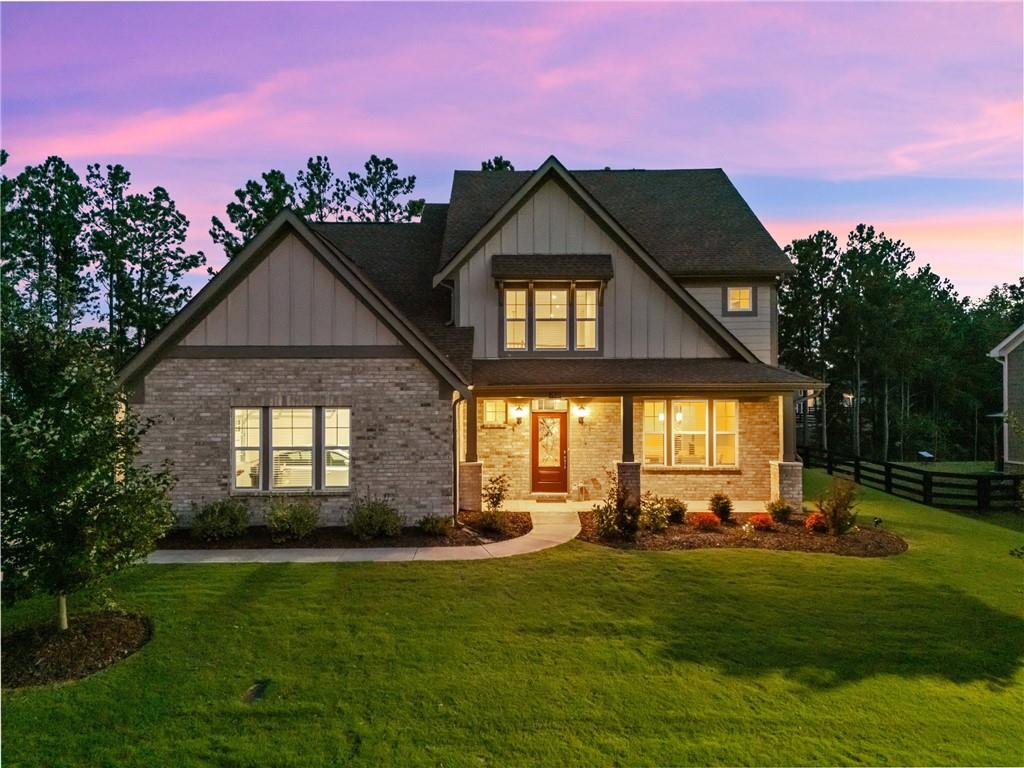 Welcome to this stunning north-facing home, built in 2022 and located in one of Forsyth County’s most desirable communities. With classic brick accents, a side-entry 3-car garage with epoxy flooring, and beautiful curb appeal, this property combines modern comfort with timeless style.
Inside, the open floor plan is anchored by rich hardwood floors and a dramatic two-story stone fireplace that creates a true focal point. The chef’s kitchen features a massive walk-in pantry, butler’s pantry, and seamless flow into the oversized dining room—perfect for everyday living and entertaining.
The main-level primary suite offers a peaceful retreat, thoughtfully positioned near the laundry room with sink for added convenience. Upstairs, you’ll find two additional bedrooms, a full bath, and a versatile loft that works beautifully as a media room, playroom, or office.
Step outside to a custom-designed backyard retreat. A flagstone patio with retaining wall, stone steps, and a natural privacy screen of trees create the perfect space for relaxing or entertaining.
All of this is set within River Rock, a vibrant neighborhood known for its resort-style amenities, active community atmosphere, and top-rated Forsyth County schools.
This home offers the perfect blend of luxury, lifestyle, and location—schedule your private tour today.