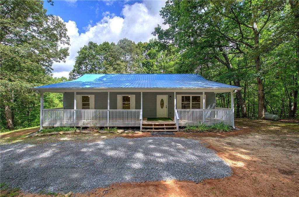Welcome to your private slice of North Georgia paradise! Nestled on a serene 5.16-acre lot, this beautifully maintained home offers peace and privacy. Located just minutes from downtown Jasper, yet tucked away enough to enjoy nature’s quiet, this property is perfect for those seeking a balance of convenience and seclusion.
Step inside and enjoy an open-concept floor plan filled with natural light, hardwood floors, and a cozy fireplace. The spacious kitchen features solid wood cabinetry, new appliances, and ample counter space—ideal for both everyday living and entertaining guests. A large primary suite with an en-suite bath offers the perfect retreat, while additional bedrooms provide comfortable accommodations for family or visitors.
The basement features a living room, two bedrooms, a full bathroom, and is stubbed for a full kitchen with a private entrance. Backyard offers a fenced-in area for your furry friends.
Outside, you'll find a spacious porch perfect for savoring morning coffee, observing wildlife, or taking in the sunset. The expansive yard features mature trees, level areas for gardening or play, and ample space for future additions, such as a workshop or guest cottage.
Whether you're looking for a full-time residence, weekend getaway, or investment opportunity in the beautiful North Georgia mountains, 1337 Talc Mine Road is the perfect place to call home.