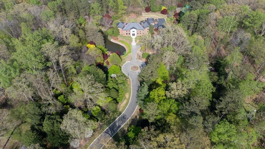 Amazing opportunity to own one of Atlanta's iconic estate properties on +/- 9 acres of manicured gardens, lake and par 3 golf hole.  Recently TOTALLY RENOVATED, this property is spectacular!!  Fabulous primary suite with his and her baths and huge closets. Beautifully redone kitchen and family room with covered outdoor porch overlooking the pool and tennis court.  Seller redid all the grounds and added a practice golf hole. There is also a log cabin on site which is a charming venue for entertaining. The 4 car garage can easily be expanded  for the car collector.  For the buyer who wants total privacy, this gated property provides an oasis within minutes of all the city has to offer.  Truly a very special opportunity!!  More photos and video coming!!