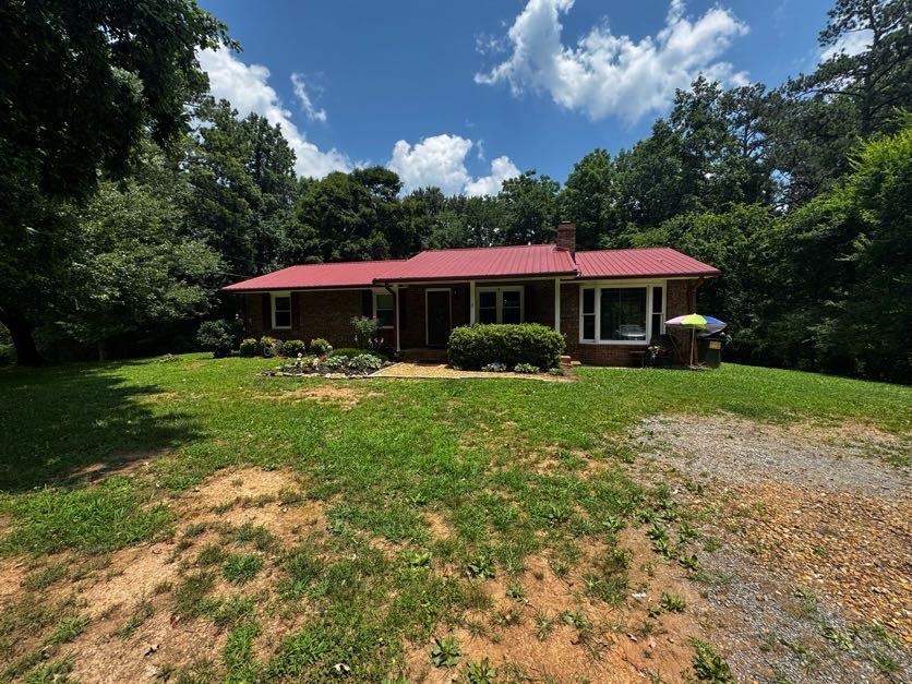 Attention investors and homebuyers! Investor special Sold in its current as is condition, this sturdy brick ranch, built in 1979, features three bedrooms and with an open-concept layout connecting the living and dining areas into a bonus room anchored by a wood-burning fireplace perfect for everyday comfort .It's situated minutes from Lake Allatoona, offering convenient access to outdoor recreation Situated on a spacious,it includes a deck overlooking a generous yard that offers excellent potential for personalized outdoor living ,property offers a perfect balance of serene lake life and city convenience. Construction highlights include durable four-sided brick, a metal roof, central air, and electric heating for reliability, parking is accommodated via an open area off a private gravel road there, no garage . This property presented an excellent opportunity for first-time buyers, empty-nesters, or investors looking for renovation potential and personalization. Cash , conventional or FHA are welcome .