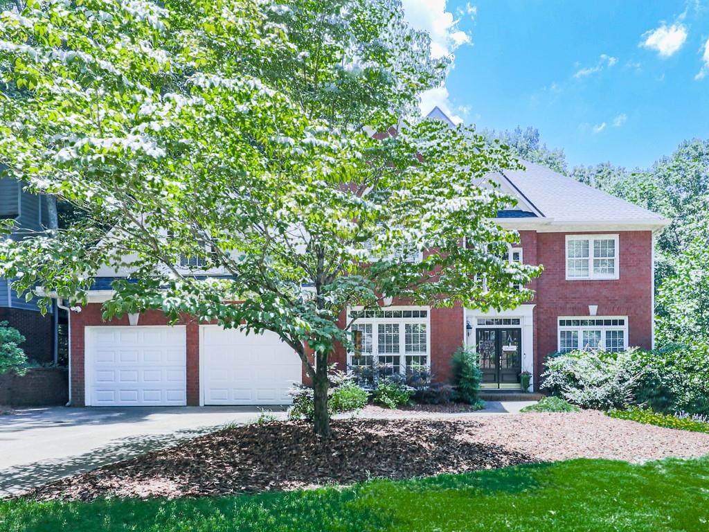 A perfect place to call home! This 5BR/3.5BA home is nestled in The Fairways, a golf community with top-tier amenities including a clubhouse, pool, tennis, pickleball, and playground. The open kitchen flows into a spacious living room with a stunning two-sided stone fireplace shared with the sunroom—a perfect spot for morning coffee. Upstairs you'll find generously sized bedrooms and a peaceful primary suite with a spacious en-suite bath. The finished basement offers hardwoods, a second kitchen, wet bar, murphy bed, and full bath. Outside, enjoy the covered porch which is perfect for watching your favorite game. The backyard is large and flat with room to play or entertain