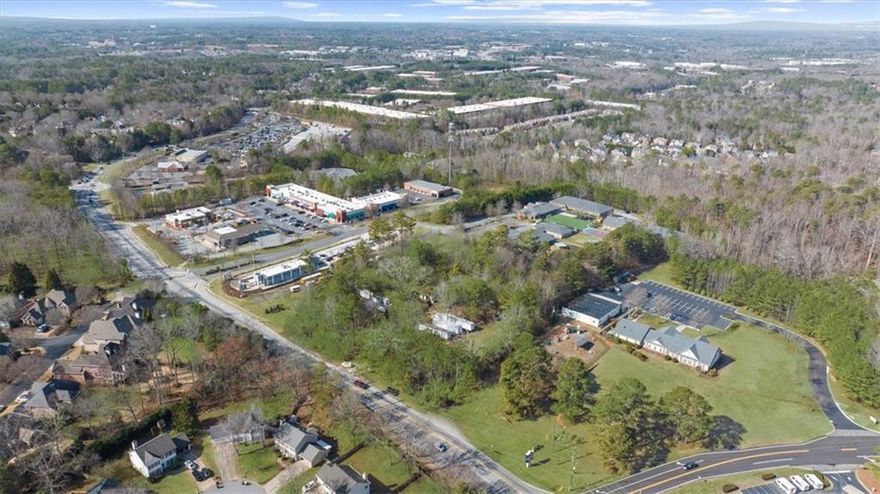 **Prime Commercial Opportunity in Alpharetta!** Welcome to 5370 McGinnis Ferry Road, a 2.23-acre commercial lot offering endless possibilities. This relatively level, flat property is the perfect canvas for your dream business. While an existing structure is on-site, it’s ready to be cleared, making way for new development. The impressive road frontage on McGinnis Ferry is sure to impress, as it will grant excellent visibility for your new business given it is a main thoroughfare and close to so many popular destinations! Located in a high-demand area near a Publix anchored shopping center at McGinnis Ferry Road and Windward Parkway, popular fast-food chains, thriving residential communities, top-rated schools, affluent demographics, and major roadways, this lot boasts unbeatable visibility and accessibility. Whether you're planning a retail space, storage units, office complex, or service-oriented business, this prime location is ready to bring your vision to life. Seize this opportunity to invest in Alpharetta’s booming growth corridor!