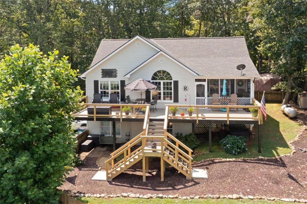 Enjoy breathtaking mountain views from the brand-new decks of this beautifully updated 3-bedroom, 3-bath home, perfectly situated in Dahlonega. Step inside to an inviting open-concept living and dining area featuring vaulted ceilings, rich granite countertops, and stainless steel appliances that make the kitchen. A spacious media room/office offers flexible space for remote work, entertainment, or hobbies. Pool table game room also on basement level. The screened-in porch and fenced yard provide the perfect blend of indoor-outdoor living-ideal for relaxing or entertaining while soaking in the scenery. Whether you're searching for a full-time residence or a mountain getaway, this home checks all the boxes.