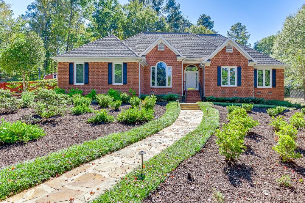 Located in the heart of Oconee County’s award-winning school district and just minutes from downtown Watkinsville, this 4 sides brick RANCH on almost an acre is a RARE find in one of Oconee’s most desirable areas! This property BACKS UP to the new 100-acre Thomas Farm Preserve, creating ultimate privacy. Positioned in an established subdivision on a cul-de-sac lot, this home has great curb appeal! The picturesque, fenced front yard features an elegant, symmetrical design with a charming stone pathway and curated perennial beds. It is an outdoor space that requires minimal maintenance while delivering maximum visual impact. Upon front door entry to the Foyer, you are greeted by vaulted ceilings, sparkling chandeliers and stunning marble flooring that spreads to the Great Room ahead, Dining Room on the left, and through to the Kitchen. A built-in desk (or coffee bar), granite island with seating, floor to ceiling open-pane windows and commodious eat-in area makes for the perfect space to dine and entertain. Off the kitchen you will find a large, walk-in laundry room with cabinets, garage entryway, and access to the back patio/yard. Opposite the kitchen, you’ll find two Secondary bedrooms featuring natural hardwood floors, a full, renovated hall bathroom, and the Primary Suite. Natural light beams in the Primary Suite, which hosts a trayed ceiling, His and Hers closets, and a luxury, newly-renovated Primary Bathroom! The Primary Bathroom features His and Hers vanities, floor to ceiling marble tile, frameless shower, and jetted freestanding bathtub. This home features a long list of upgrades - Newer 12x20 shed, tankless water heater, new irrigation system, fully renovated bathrooms, open pane windows, to name a few. THIS LOCATION CAN’T BE BEAT! Just around the corner from downtown Main Street - a hub for great shopping, delicious dining, a thriving business, community events, and an arts community. Close proximity to Thomas Farm Preserve and Rocket Park (3 min), Wire Park (6 min), Publix (10 min), Sanford Stadium/Downtown Athens (16 min), Trader Joes (18 min) and easy access to Hwy 441. And to top it all off, this home is located in the highly ranked schools of Oconee Primary, Oconee Elementary, Oconee Middle School and Oconee High School.