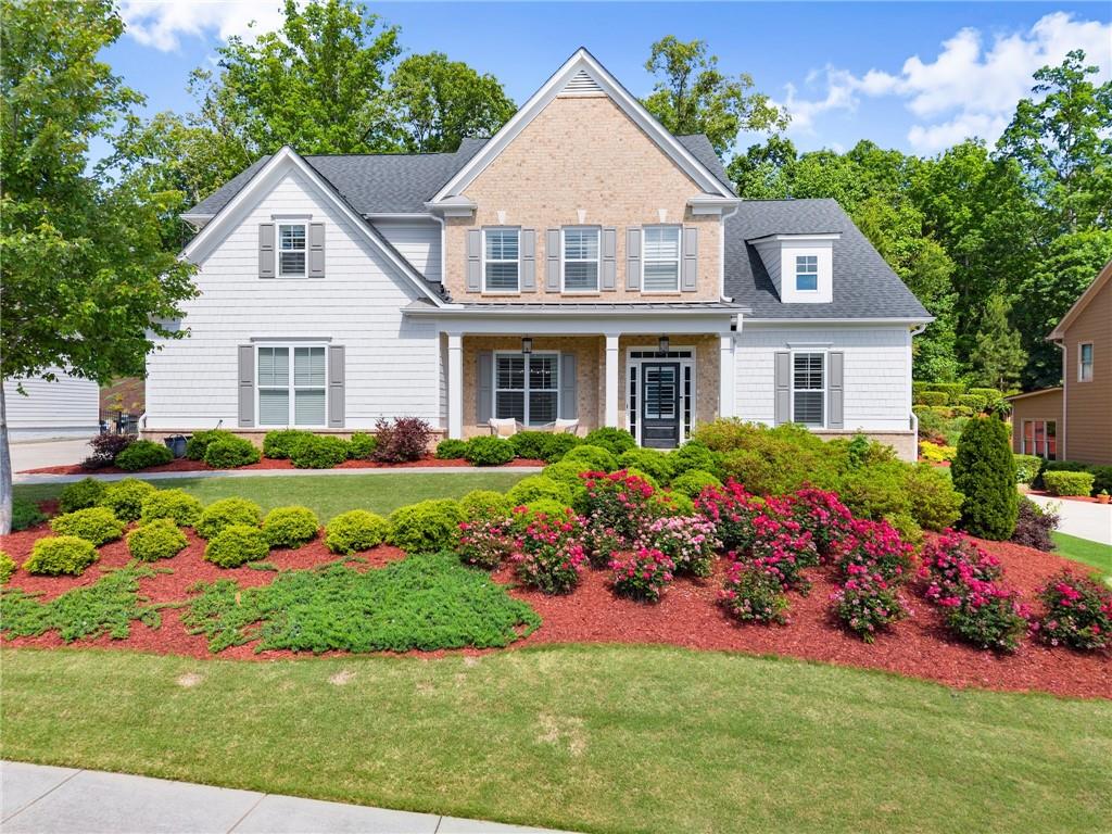 MAJOR PRICE IMPROVEMENT- BRING AN OFFER! This home is an elegant 5 bedroom 4.5 bath home tucked within the sought after gated community of St. Michael's Bay on Lake Lanier. Built in 2018, this former model home has all of the upgrades one would want with modern comfort, beautiful landscaping and a 300 square foot addition added on the back of the home to enjoy all 4 seasons with it's own heating/cooling and WINDOWS GALORE with MASSIVE SLIDER DOORS TO BRING THE OUTDOORS INSIDE! The stunning main level is open concept anchored by a two story great room with built in shelving surrounding the cozy fireplace. Chef's kitchen features a massive island with sleek quartz countertops and bright white cabinetry perfect for entertaining or family nights in. Enjoy the convenience of a main level owner's suite with soaring ceilings, spa like bath with double vanities, soaking tub and separate shower. A second ensuite bathroom also is on the main level large enough for a king bed! Laundry with sink and mudroom finish out the main. Upstairs includes 3 more very large bedrooms and 2 bathrooms, one being in between two bedrooms (jack and jill bathroom) and the other one being inside the 3rd bedroom. Lots of attic and closet space for all of your storage needs! Last but not least are the beautiful outdoor areas including a welcoming front porch and again, a FOUR SEASON ROOM with it's own HVAC system, high quality slider glass doors to open up, skylight windows, tongue and groove ceiling that leads to the backyard that is larger than it looks! The lot keeps going further back! It's the PERFECT SPACE to entertain, relax and bring the outdoors INSIDE. St. Michaels Bay amenities are second to none with a resort style pool, pickleball court, tennis court, access to Lake Lanier to fish, swim, or pull your boat up temporarily. This property is the PERFECT BLEND of Lake Life and neighborhood life with a home that has it all!