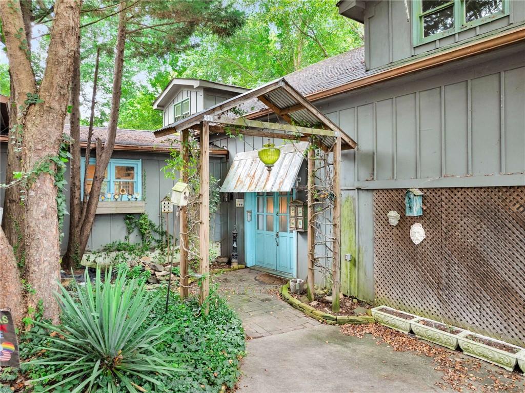 **THIS SALE INCLUDES 2 LOTS**Ignite your imagination in this creatively inspired 3-bedroom, 3.5-bath residence located in the charming historic district of College Park. This “artistic chic” home encourages you to envision grand possibilities and turn it into your personalized masterpiece! Accompanying the sale is an additional lot, totaling nearly an acre offering limitless potential for expansion or even the construction of a second dwelling. Oozing with curb appeal - step inside to discover a vast great room featuring a soaring two-story ceiling that will leave you saying WOW! The expansive main living area is adorned with 2 fireplaces, enhancing the atmosphere and inviting multiple spaces for gatherings and entertainment. Designed with a thoughtful layout, the home includes separate wings that ensure maximum privacy, making each bedroom a personal retreat. Flexible spaces throughout can easily serve as offices, libraries, additional living areas, and more! Each bedroom is equipped with its own en-suite bath, while the primary suite boasts a private sitting area and outdoor deck—a perfect sanctuary! The generous outdoor spaces offer peaceful spots to unwind beneath a lush green canopy or host friends and family. Ideally situated, you'll enjoy quick access to Atlanta’s lively hotspots in College Park, Hapeville, and East Point Villages, Woodward Academy along with easy highway connections and proximity to Atlanta’s airport for those spontaneous trips or business travel. Seize this unique opportunity to craft the home of your dreams in a highly desirable location!