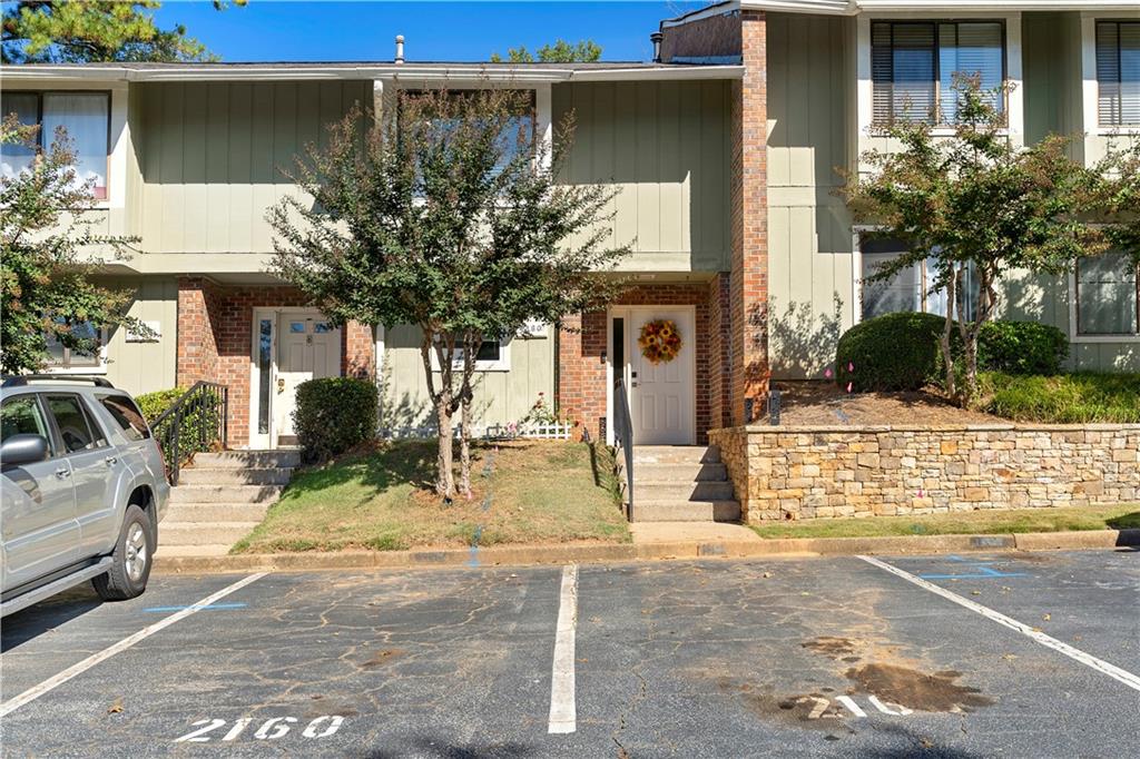 Welcome home to this beautiful 2 bedroom, 2.5 bath condo that perfectly blends modern style with everyday comfort. The open concept main level features a spacious living area with a wet bar connecting the dining space and living room along with sliding glass doors that open to your own private fenced yard, perfect for relaxing or entertaining. The kitchen is a true highlight, showcasing granite countertops, two tone cabinetry, stainless steel appliances, and a subway tile backsplash. Upstairs, both bedrooms are generously sized with plush carpeting, large closets, and updated baths with contemporary finishes. The primary suite includes a private balcony for enjoying morning coffee or evening breezes. Smart home features add modern convenience and efficiency throughout. Ideally located near many shopping and dining options, this move in ready condo offers the perfect combination of comfort, style, and convenience.