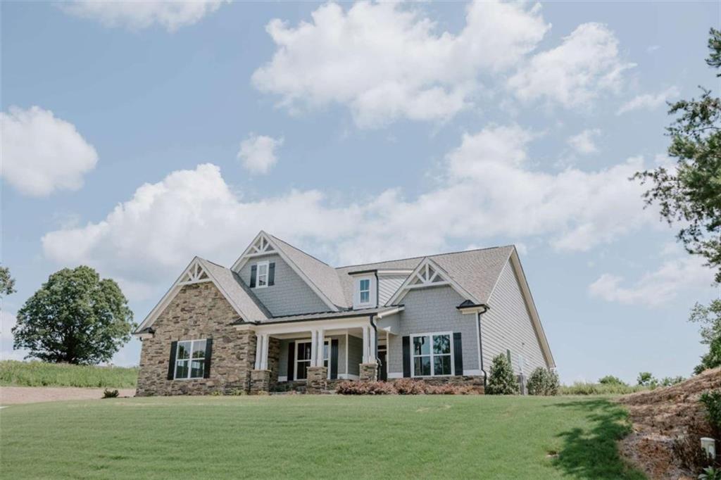 Stunning Craftsman Home in Habersham County - Built in 2022, Shows Like New! Seller is offering closing cost help with an acceptable offer. Welcome to this beautifully maintained 4 bedroom, 3 bathroom Craftsman-style home, built in 2022 and offering timeless charm with modern conveniences. Situated on a manicured lot with professional landscaping, this home features classic Hardiplank siding accented by stone and cedar shakes, a side-entry garage, and true Craftsman detailing throughout. Step inside to find arched openings, decorative transom windows, and exquisite trim work that highlight the home's architectural style. The living room boasts a coffered ceiling, stone fireplace, and a wall of windows that fill the space with natural light while offering views of the private backyard. Perfect for entertaining, the open-concept layout flows seamlessly into the chef's dream kitchen, complete with a massive island, double wall ovens, gas cooktop, walk-in pantry, and plenty of cabinet space. The spacious primary suite on the main level is a true retreat, featuring a luxurious en-suite bathroom with a freestanding soaking tub, double vanities, oversized frameless tiled shower with built-in seat, and a large walk-in closet. Additional highlights include a walk-in laundry room, generous secondary bedrooms, and custom finishes that carry the Craftsman theme throughout. Located in scenic Habersham County, this home offers a rare opportunity to enjoy modern living with the charm and craftsmanship of a classic architectural style. Don't miss this one! Agent related to seller.