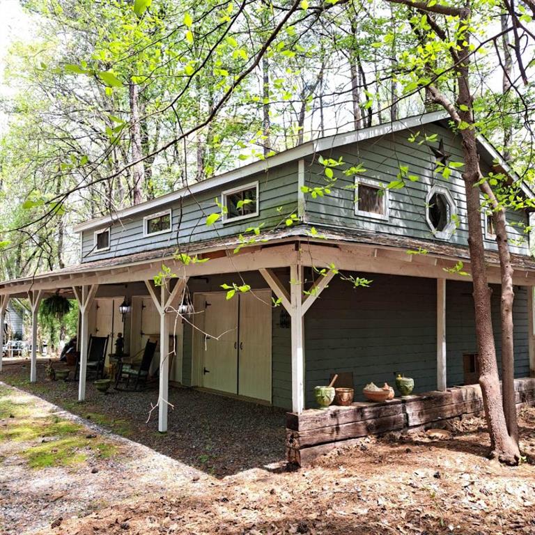 Charming garage apartment located on a beautiful gated five acre estate. You will love the tranquil, peaceful setting in the rural horse country of Alpharetta, Georgia. Encounter the wonders of nature with grazing deer, wild turkey or Canadian Geese on a nearby pond. The lovely furnished carriage house type apartment is located on five acres with one other private residence. Overlook a beautiful wooded lot from your front porch/deck. You'll enjoy the private and peaceful living absent in multi-family apartment communities. This charming furnished apartment features two bedrooms and one full bath. There's a spacious great room with a dining area and a pass through bar to the eat-in kitchen. The great room also features built-in bookshelves and a small built-in desk. The apartment includes a one car garage with an auto garage door opener and there's plenty of additional parking as well. Water and garbage included. High efficency electric mini-split system for heating and air. No pets please. This is a one-of-a-kind apartment that you will love if you love nature. Hurry and visit today!