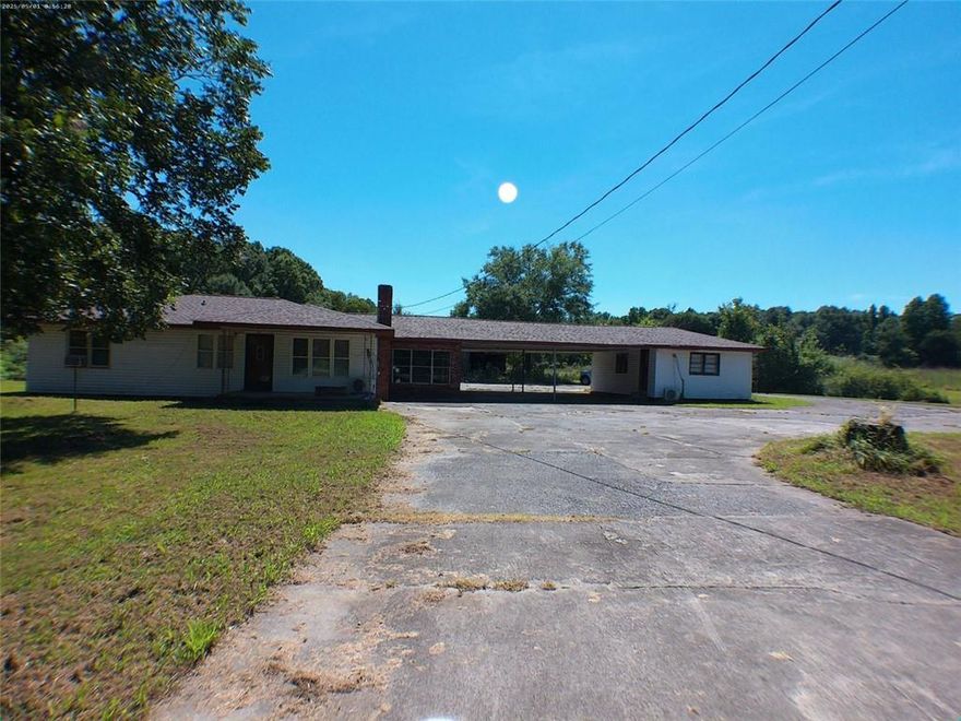 4.49 Acres, (including the land across street from the house) 3 bedrooms, 2 bath, a room to the Right of the carport has a half bath and can turn into a bedroom.  Sold As Is.