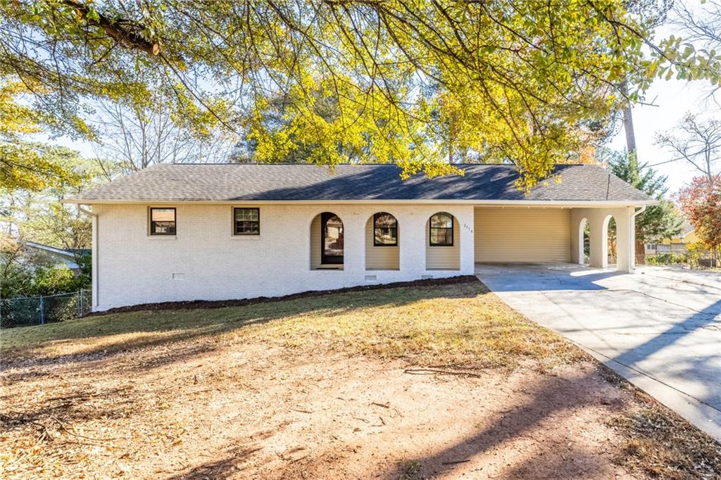 Welcome to this charming brick ranch home with freshly painted interiors and exteriors. This property features a spacious, fenced backyard perfect for outdoor enjoyment. The newly renovated kitchen seamlessly connects to a cozy family room with a fireplace, offering flexibility as a keeping room or formal dining area. The primary suite includes a private en suite bathroom with a bidet, while two additional bedrooms share a full bath. Step out of the living room into a beautiful sunroom with high vaulted ceilings—a perfect retreat for relaxation, entertainment, or simply enjoying views of the expansive, flat backyard. The oversized unfinished basement provides ample storage space and potential for future living areas. Conveniently located with easy access to Lawrenceville Highway, I-85, Ronald Reagan Parkway, and Sugarloaf Parkway, this home offers charm, comfort, and a prime location.