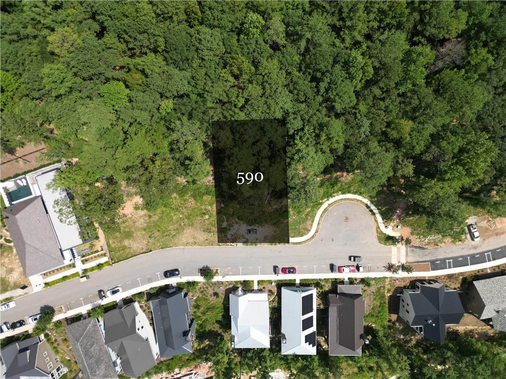Perched along the Lupo Loop ridge line, this 0.21-acre estate lot offers the perfect setting to build your dream home, complete with panoramic treetop and sweeping sunset views. A prepared architectural plan featuring a terrace-level garage is already in place, allowing you to move forward with ease. Just a short distance from shops, dining, and health + wellness amenities, this homesite also provides direct access to over 20 miles of soft-surfaced nature trails, bringing the beauty of the outdoors right to your back door.