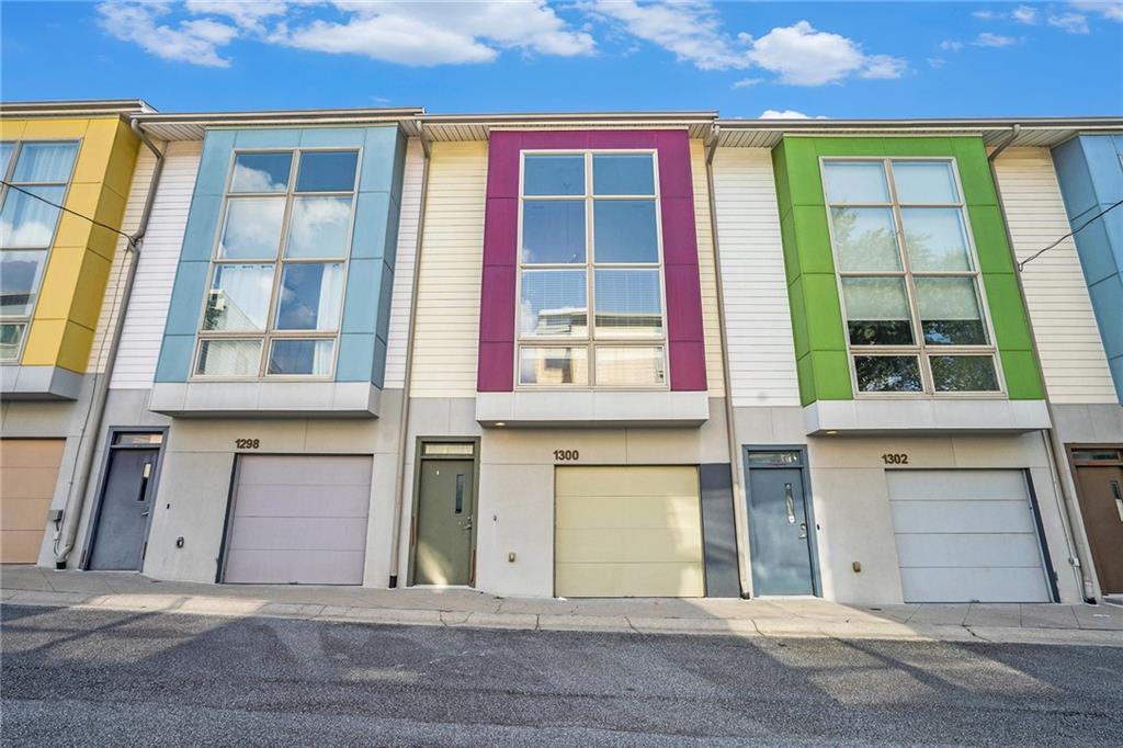 Modern 3-story 2BR/2.5BA townhome in the heart of West Midtown! Bright, open-concept main level with soaring 20’ ceilings, floor-to-ceiling Pella windows, and newly refinished hardwood floors. Stylish kitchen features granite counters, stainless steel appliances and generously sized pantry—plus access to a private deck and stairs leading to a private backyard with recently updated fencing. Oversized primary suite offers a spa-inspired Euro-style bath, walk-in closet, and in-room laundry. Private terrace-level bedroom with en-suite bath opens to the backyard—ideal for guests, in-law setup or home office. One-car attached garage at terrace level. Wonderful, gated community with pool, fitness center, clubhouse, and dog park. Unbeatable location—walkable to numerous restaurants, Topgolf, and all the best of West Midtown!