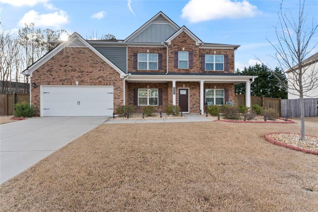 Welcome to this stunning 5 bed, 4 bath home in great neighborhood. This traditional 2 story brick front house boasts a level lot with a fenced-in back yard (with ALL lawn care included!) and covered patio...perfect for outdoor entertaining. Inside on the main level... The front door opens into the foyer. Flanking either side is a formal dining room and office or sitting room. Directly ahead is the massive open family room and kitchen. The living area features a fireplace with gas logs. In the kitchen you'll find stainless steel appliances, granite counters, and a 4 person breakfast bar. Rounding out the main level is a guest bed and full hall bath. Upstairs... There is the flexible entertainment/family room which provides endless possibilities for creating a space that suits your needs. The master suite features a trey ceiling, a tiled bath with a garden tub and separate shower, as well as dual sinks and marble counters. Also in the master is a huge walk in closet. There are 3 more bedrooms on the 2nd level. One bedroom features a walk in closet and private bath. The 2 other bedrooms share a hall bath. Another great convenience is the laundry room, is which is located on this level for easy service. Finally, the home has a 2 car garage with auto openers. Located within walking distance to schools and close to I-85 and I-985, this home provides easy access to amenities and commuting routes. Don't miss the opportunity to make this house your home. Schedule a showing today!