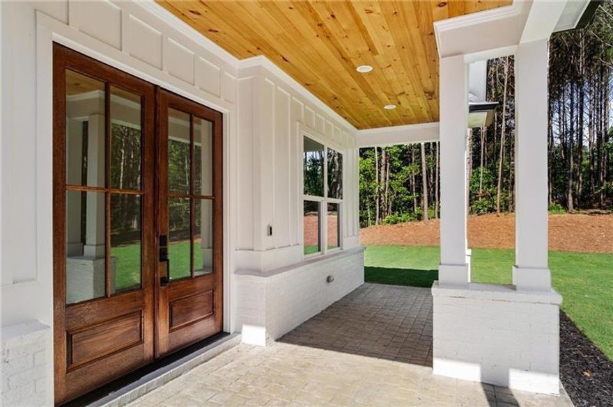 Discover this exceptional new construction home perfectly situated on a serene 3.07-acre lot in the picturesque town of Jasper, Georgia. Thoughtfully designed for both comfort and elegance, this residence combines privacy, functionality, and high-end finishes throughout its 4 bedrooms and 3.5 bathrooms.

From the moment you arrive, the home’s curb appeal impresses with a charming farm-style wooden fence, concrete driveway, stamped concrete walkway, and an inviting front porch, setting the tone for the refined living that awaits inside.

Step into an open-concept floor plan featuring 10-foot ceilings and a dramatic 12-foot tongue-and-groove tray ceiling in the main living areas. Sunlight fills the space, accentuating the rich LVP flooring and modern 60-inch electric fireplace that anchors the living room. The gourmet kitchen is a true showpiece, complete with quartz countertops, BOSCH appliances, including a dual gas range, refrigerator, dishwasher, SHARP built-in microwave drawer, and pot filler, making it ideal for both everyday living and entertaining.

The owner’s suite on the main level provides a luxurious retreat, offering dual vanities, a soaking tub, a spacious walk-in shower, and a custom California closet with built-in dressing mirror. Two additional main-level bedrooms share a well-appointed bathroom, providing comfort and privacy for family or guests.

Upstairs, you’ll find a private in-law suite complete with a full bathroom, walk-in closet, smart thermostat, and access to a large walk-in attic for convenient storage.

Enjoy outdoor living on the covered front and rear porches, or take advantage of the expansive backyard, perfect for a future pool or outdoor oasis. The oversized 715-square-foot two-car garage features a separate walk-out door and EV charger outlet.

This home is equipped with premium systems, including a Rinnai tankless water heater, Rachio 4-zone smart sprinkler system, Ring security system, Nest thermostats, and a high-efficiency 3-zoned Daikin HVAC system; one of the best warranties in the industry. It’s also pre-wired for a Generac gas generator for added peace of mind.

Conveniently located just 10 minutes from local amenities such as Publix, Home Depot, Kroger, Walmart Supercenter, and the upcoming Chick-fil-A, this home offers easy access to both nature and convenience. Carters Lake is only 20 minutes away, while Amicalola Falls State Park and the Appalachian and Chattahoochee National Forests are within easy reach. Downtown Ball Ground, Northside Cherokee Hospital, and Piedmont Mountainside Hospital are also nearby.

Blending modern elegance with peaceful rural charm, this Jasper home offers a rare opportunity to enjoy luxurious living with room to breathe.