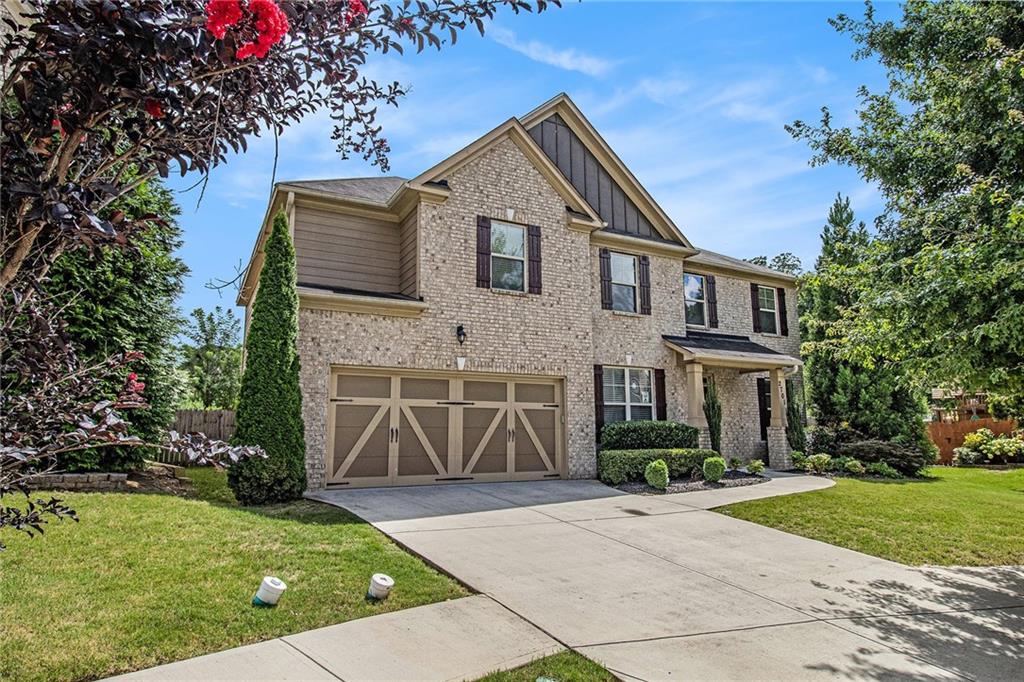 Welcome HOME to this gorgeous craftsman. This 5 bedroom 3 bath home boasts a 2 story entrance foyer for a quick wow factor, stunning hardwoods in main level hall and kitchen, and family room full of natural light sure to grab your attention. If you love to entertain, you'll want to be quick to fill out an application. Kitchen offers high end cabinets, granite counters, and stainless steel appliances, all which open to the breakfast area and family room. Step out from the breakfast area to your 12' x 16' covered back patio and soak up all the fresh air you can in the fully fenced in, MASSIVE & LEVEL backyard. The main level features a bedroom with its own en-suite bathroom great for guests! Head upstairs to awe at your master suite with stunning vaulted ceilings, and huge sitting room where you'll never want to leave! Upstairs also offers three additional spacious rooms and a laundry room conveniently located in the hall. Close to downtown Buford, shops and restaurants. Go see it in person before it's gone!