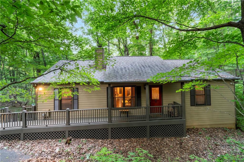 THIS CHARMING COTTAGE HOME OFFERS 5 BR'S AND 3 FULL BATHS, AN OPEN FLOORPLAN WITH HARDWOOD FLOORS AND T&G CATHEDRAL WOOD CEILING IN THE MAIN LIVING AREA. STACKED STONE FIREPLACE, BRAND NEW QUARTZ COUNTERTOPS WITH STANDARD TABLE HEIGHTH PLUS A NEW RANGE WITH WOOD KITCHEN CABINETS, WALKIN PANTRY LOCATED INSIDE THE LAUNDRY ROOM. MASTER B/R SUITE WITH SPLIT PLAN WHICH INCLUDES TWO OTHER BEDROOMS WITH SHARED FULL BATH ACCESS LOCATED, ALL OF WHICH ARE LOCATED ON THE MAIN LEVEL. ON THE TERRACE LEVEL IS AN EXPANSIVE FAMILY ROOM WITH TILE FOORS, 2 ADDITONAL BEDROOMS ALTHOUGH ONE IS CURRENTLY BEING USED AS A MUSIC ROOM/STUDIO, AND BOTH HAVE DIRECT ACCESS ONE LARGE FULL BATH PLUS TWO SEPARATE STORAGE ROOMS. TILE FLOORING DOWNSTAIRS, SCREEN PORCH ADDITION ON THE MAIN LEVEL WAS ADDED IN LAST 4 YEARS, MASTER BATH VANITY AND TILE FLOORING ADDED, THE ROOF AND HVAC SYSTEM WERE REPLACED 5 YEARS AGO IN 2020. HARDI-BOARD EXTERIOR SIDING, ZERO ENTRY (NO STEPS) FRONT PORCH WITH SCREEN PORH PLUS AN OPEN DECK ON THE MAIN LEVEL, AND A LARGE COVERED PORCH ON THE TERRACE LEVEL. THE BACKYARD SETTING IS PRIVATE AND ENJOYS A YEAR RUNNING STREAM PLUS A LEVEL DRIVEWAY THAT CAN EASILY ACCOMMODATE EITHER A CARPORT/2 OR GARAGE/2 IF SO DESIRED. TRULY AN OUTSTANDING VALUE FOR BIG CANOE, AND WELL WORTH CHECKING OUT!