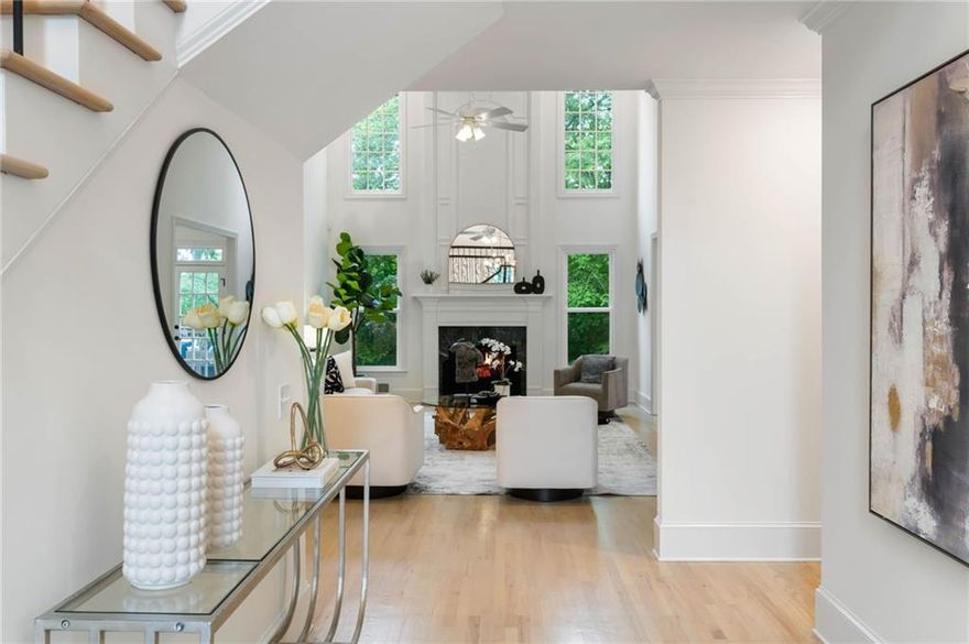 This description paints a vivid picture of a luxurious and well-designed home.  The floor plan showcases a thoughtful layout with functional and aesthetically pleasing spaces.  Here's a breakdown of it's features:  Versatile suite located to the left upon entry, adaptable for use as an office, guest room, music room, or playroom and it includes a full bathroom.  To the right a formal living room leads to a large separate dining room with a butler's pantry. A two-story vaulted great room features a marble fireplace and walls of windows, ensuring ample natural light. Equipped with granite countertops, stainless steel appliances, extra built-in cabinets with display glass, a wine fridge, a walk in pantry, breakfast bar and table, making it perfect for culinary enthusiasts. Light hardwood floors throughout the main level adds touch of a modern elegance.  Laundry room is an oversized space with built-in cabinets and laundry sink for convenience. The primary suite is expansive, with a separate sitting room featuring a marble fireplace, built-in bookshelves and cabinets, two full bathrooms, and spacious separate closets providing luxury and privacy.  Completing the secondary level are three bedrooms with walk-in closets, one en-suite. Terrace level is finished as an in-law or au pair suite with kitchen, bedroom, bathroom and closets.  The piece-de-resistance in this home is the custom media room where one can enjoy streaming favorite shows or movies.  Don't forget the glassed in porch perfect for mediation or reading. Side entry three car garage with shoe closet and storage racks can keep your tools organized.  This floor plan indeed emphasizes both functionality and luxury, with spaces that cater to a wide array of needs and preferences.  This home is truly modern elegance intertwined with comfort.