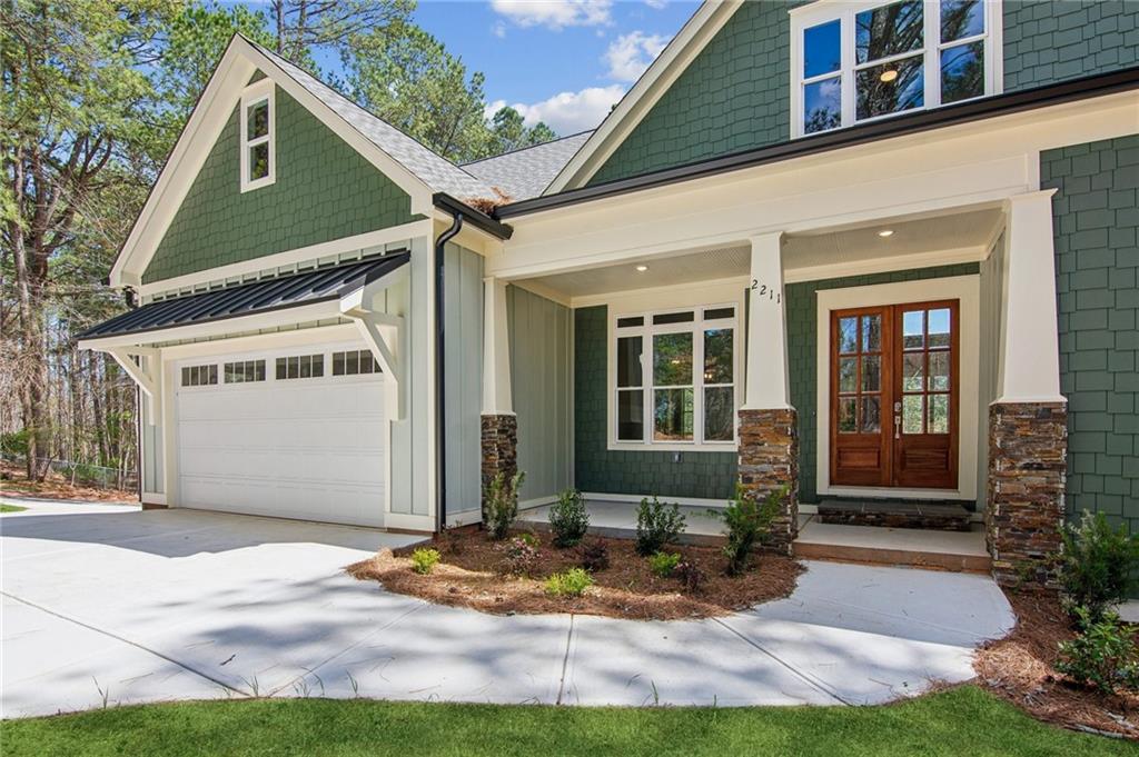 Tucked just two miles from downtown Dawsonville, this brand-new craftsman home sits on over an acre with no HOA and offers a rare blend of privacy and luxury. Step inside to soaring ceilings, rich hardwood floors, and a stunning kitchen built for gathering, complete with a 48" gas range, custom cabinets, wine cooler, and a spacious island perfect for morning coffee or hosting friends. The owner’s suite on the main level feels like a retreat with its spa-style bath, while upstairs, hidden bonus rooms offer playful, flexible space for a home theater, gym, or creative studio. With a full daylight basement, smart garage, and a covered back porch overlooking your private yard, every detail invites you to settle in and stay awhile. Just minutes from local wineries, Amicalola Falls, hiking trails, and the North Georgia Premium Outlets, this home brings comfort and adventure together in one unforgettable setting.