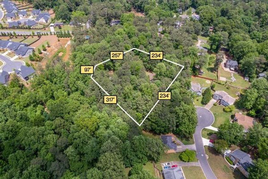Rare Find in One of Marietta’s Most Coveted Areas! Nestled on a sprawling 2.5-acre level lot, this property offers the perfect blend of seclusion and convenience. Located down a long driveway lined with towering trees, the setting feels like a peaceful countryside retreat, yet it’s just minutes from key amenities. Surrounded by tranquil hardwoods, this expansive lot provides endless possibilities—whether you’re envisioning a custom-built estate or enhancing the existing structure to create your dream home.

With 2.5 acres of land, there’s plenty of room to design outdoor living spaces, add gardens, or construct additional buildings. The property’s layout also makes it ideal for those needing space for multiple vehicles, storage, or a home-based business. A substantial barn/garage with electricity (approx. 1,600 sq ft) adds to its versatility, offering plenty of room for storage, hobbies, or workspace.

Located in a prime area, this property offers quick access to major interstates, including I-285, making commuting a breeze. You’re just a short drive to Downtown Marietta, Downtown Smyrna, and Truist Park, home of the Atlanta Braves, ensuring plenty of options for dining, shopping, and entertainment. With Hartsfield-Jackson Atlanta International Airport approximately 22 miles away, travel is easy, whether for business or leisure.

This property perfectly balances tranquil, private living with the convenience of easy access to the area’s top destinations. Don’t miss this rare opportunity to own an expansive piece of land in a prime location—ready to build your ideal retreat!