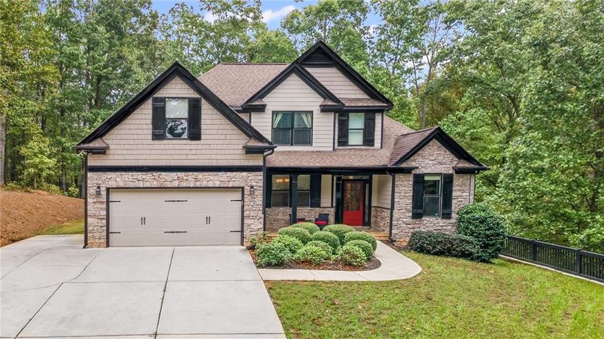 JUST LISTED ON 2.05AC! Tucked away on a quiet, upscale cul-de-sac, this stunning home offers ultimate privacy on over 2.05 AC! Wonderful Outdoor Living!  This Pristine Owners' on Main features beautiful details throughout.  Gorgeous Harwood Floors Galore!  Dramatic vaulted Great Room with Real Wood Burning Fireplace open to the Gourmet Kitchen - PERFECT for entertaining family and friends!  Stunning Island Kitchen features beautiful cabinetry, stone countertops, SS appliances, undercabinet lighting, coffee station, and more! Flowing seamlessly into the elegant dining room with a coffered ceiling—perfect for hosting gatherings with seating for 12+. The luxurious owners' suite on the main boasts double rectangular sinks on stone countertops, a frameless shower, a soaking tub, and designer tile, plus a huge walk-in closet! Spacious Secondary Bedrooms on the second floor include an extra-large bedroom/bonus room/office!  Enjoy outdoor living at its finest with a large screened porch featuring a stacked stone fireplace and an upscale deck with an Amazing Hot Tub overlooking the peaceful, private, fenced yard.  All this and more sits above a full, unfinished basement, ready for your personal touch.  An Extra Parking Pad has been added for additional convenient parking! NEW CHEROKEE HS CAMPUS PLANS TO OPEN FALL 2026!  Swim/Tennis/Golf Memberships available at nearby Bridgemill.  Minutes from Lake Allatoona, this home is undoubtedly the one you've been searching for!