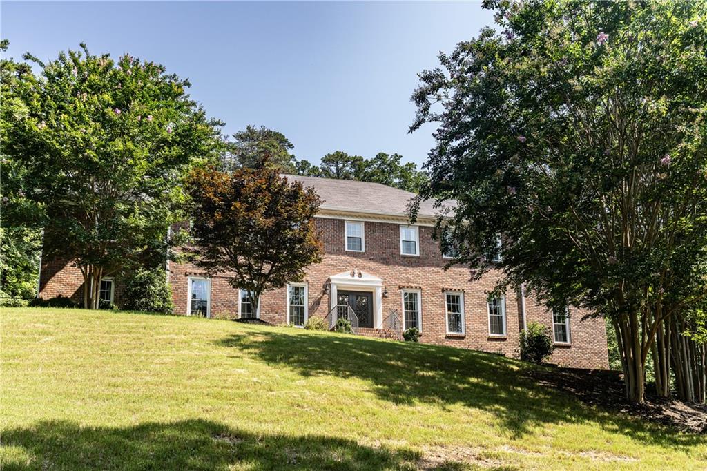 Looking for land and privacy without leaving the city? This classic brick home is nestled at the edge of the Marshall Forest, offering serenity, seclusion, and convenience. A long, winding gated driveway leads you to your own private retreat and a newly widened asphalted driveway. First glance shows a brand new roof!!! Inside, you'll find 6 spacious bedrooms - possibly up to 8, with two primary suites (one on each level). Need flexibility? There's a large workout room and a study upstairs that can easily serve as additional bedrooms or bonus rooms. The updated kitchen features all the modern upgrades you expect, and both bathrooms have been stylishly refreshed. Entertain with ease in the huge separate dining room, a formal living room (or potential office), and a precious breakfast nook with peaceful views of the forest. Enjoy outdoor living on the new oversized deck or relax year-round in the sun porch with hot tub. With space to grow and gather, this is a home built for lasting memories - whether you're expanding your family or simply seeking a private haven in town.