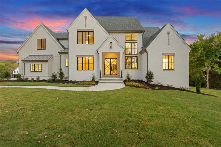An incredible new price creates an exceptional opportunity to own this custom-built estate in a premier Canton location on 2+ acres!  Dramatic custom glass entry doors open to a show-stopping three-level staircase, 7” wide-plank white oak floors, and soaring vaulted ceilings. The heart of the home features a limestone fireplace and seamless indoor-outdoor living, with 12' accordion doors that open to expansive beamed porches overlooking the private estate. The chef’s kitchen includes Thermador appliances, custom cabinetry, stunning oversized quartzite waterfall island with seating, a mix of natural wood tones, and Brizo Litze fixtures. A separate scullery features an arched entryway, showcasing Bardiglio and Carrara marble checkered floors, café-style drawer dishwasher, black fireclay farmhouse sink, and designer hardware. The custom details like the reeded Calacatta Viola marble floating 54" sink basin and designer lighting add luxurious sophistication to the adjacent bath. The main-floor owner’s suite impresses with a beamed ceiling, private veranda, and a spa-worthy bath featuring heated herringbone marble floors, a zero-entry shower, and stunning vanities. Upstairs, four spacious en-suite bedrooms offer comfort and style, while the terrace level is designed for entertaining with a sleek micro-shaker bar, media space, and access to a flat, POOL READY backyard. Bevolo gas lanterns, custom corbels, and Pella Aluminum Clad Casement windows lend timeless character to the exterior. With high-performance windows, foam insulation, a Ruud HVAC system, and smart prewiring throughout, this home blends modern technology with enduring craftsmanship—just minutes from Milton and downtown Alpharetta, with the added benefit of Cherokee County taxes. Preferred Lender offering a $6K credit to be applied toward closing costs, prepaid items, or an interest rate buydown, subject to approval.