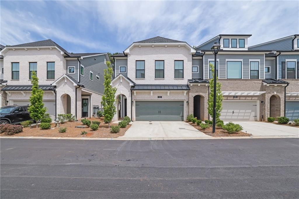 This beautiful corner lot is only 5 minutes from Canton street and downtown Roswell! It includes 3 bedrooms on the 2nd floor, 2 full bathrooms, 2 half baths, and the loft space is the entire 3rd floor, that can be utilized as an additional bedroom, a gym, an entertainment space, an upstairs office, the possibilities are endless with this top floor boasting an estimated 900 square feet with an additional area for storage on this top level.
The main level features an open-concept layout with 10-foot ceilings, connecting the kitchen, dining, and living areas. The kitchen is well-equipped with a gas cooktop, stacked cabinetry (special feature), an oversized island, and curated design finishes that balance style and function. Upstairs, the owner's suite includes a sitting area and screened-in porch, with a bathroom offering a soaking tub, frameless shower, double vanity, and walk-in closet. Two additional bedrooms and a shared full bath with double sinks provide ample space for guests or family members.
The outdoor covered patio and fenced yard offer additional living space, and the surrounding neighborhood is quiet and gated, with tree-lined streets and shared amenities including a swimming pool, cabana, and dog park. The location provides convenient access to downtown Roswell, Avalon, Alpharetta, and GA 400. Lastly it's in a highly rated school area which is great if you have children and useful if you ever need to sell the home in the future.
