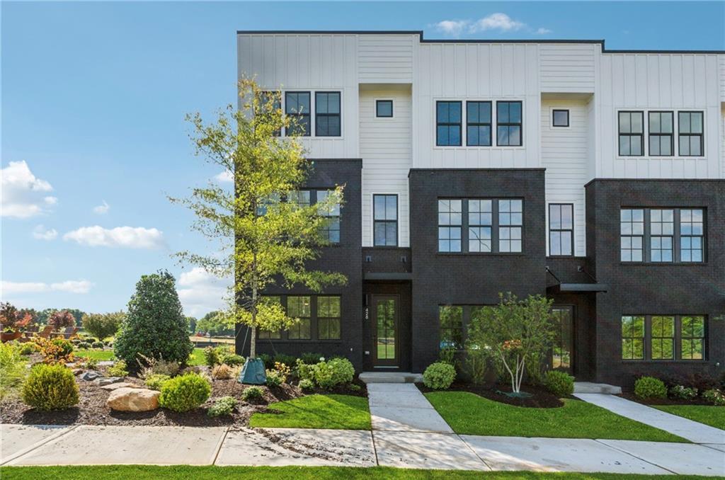 **End Unit!! NEW CONSTRUCTION!! This stunning 4 bed/3.5 bath home is in a highly coveted community at The Gathering Alpharetta, offering exceptional lifestyle and tranquility. This exquisite property boasts a most prime location- just minutes from Avalon, downtown Alpharetta, top-rated schools, vibrant shops, and gourmet restaurants. The home’s notable features include a thoughtful layout and stylish finishes, unmatched upgrades, abundant natural light, oversized windows, whole house wood blinds, elegant and durable luxury vinyl plank flooring flows seamlessly throughout enhancing the home’s cohesive design. The foyer welcomes you into a generously sized guest suite with a full bathroom and access to the two-car garage. Transitioning to home’s upper retreat, it opens to the spacious living room featuring 10 ft ceilings and open floor plan. The chef's kitchen highlights the oversized quartz island, ample storage, sleek ceiling height white cabinets, and upgraded Kitchen Aid stainless steel appliances. Retreat to serene master bedroom offering ensuite spa-inspired bathroom impressing with glass enclosed walk-in shower and double vanity, and generously sized walk-in closet. Additional two secondary bedrooms provide flexibility for guests or home office. Shared full bathroom and laundry room completes the upper level. Residents enjoy convenient access to well-maintained fire pit, community garden, and dog park. Experience the lifestyle you have dreamed of. Schedule a private showing today!