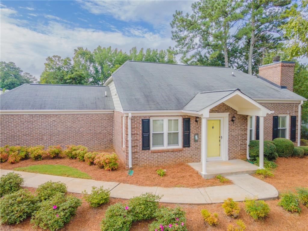Welcome to easy one-story living in this beautifully updated home, ideally situated on a landscaped corner lot in the heart of East Cobb. This bright and airy residence is filled with natural light, enhanced by fresh neutral paint and LVP flooring throughout for a low-maintenance lifestyle. The modern kitchen features stainless steel appliances, sleek finishes, and opens seamlessly to a spacious dining room-perfect for entertaining. Cozy up in the inviting living area with a charming fireplace, or relax in the sunroom, surrounded by peaceful views of the manicured grounds. Enjoy peace of mind with an HOA that covers grounds and street maintenance, sewer, water, and street lights. The active community offers a vibrant social life with regular events at the pool and pavilion. All this just minutes from shopping, dining, and entertainment, with easy access to downtown Roswell, interstates, and nearby trails. Don't miss this opportunity to live in comfort and style!