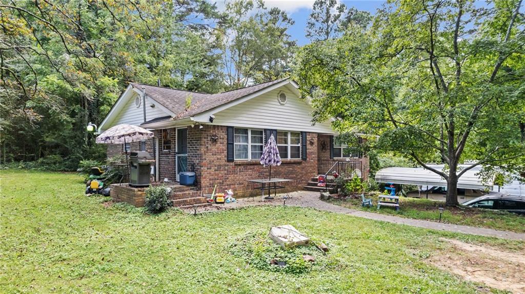 Charming 3-bedroom, 1-bath brick home with hardwood floors throughout, featuring a separate dining room and spacious living room. Located on 1.72 acres per public records of gently sloped land in a peaceful country setting, yet less than 10 minutes from downtown. Modern comforts include central heat and air. Situated in the desirable Model School district. Sold as-is, with a flexible closing date on or after November 1st. Showings require 24-hour notice. There is a shared driveway to the home. Ideal for buyers seeking tranquility with convenient access to city amenities! ***Home is USDA Eligible***
