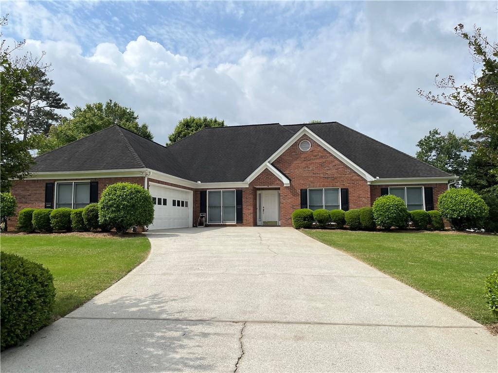 Must see Inside this Lovely Brick Front Ranch Home With 4 Bedrooms & 2 Baths located in the Mill Creek High School District. This Home Features a Huge Greatroom, Separate Formal Dining Room with Tray Ceiling, Large Owner's Suite with Tray Ceiling and Bath that has a Separate Shower and Garden Tub and a Large Walk-in Closet with Custom Shelving. Relax in the Sunroom that looks out on the Wooded Backyard. House is Located in the Back of the Neighborhood on a Cul-de-sas Street. It is Within Walking Distance to the Ashton Wood Swim/Tennis Area. Ashton Wood is a Voluntary HOA. The Swim/Tennis Membership is $450.00 Annual Fees and the Basic Membership is $120.00 Annual Fees. This Home is very convenient to Shopping, Restaurants, the Hamilton Mill Library and easy access to I-85. This is an Estate Sale and Sold As Is. Owner/Agent