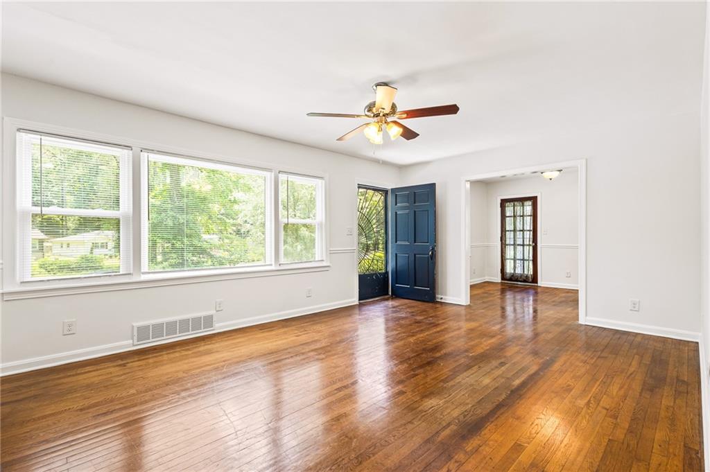 Empty room with ceiling fan and wood-type flooring