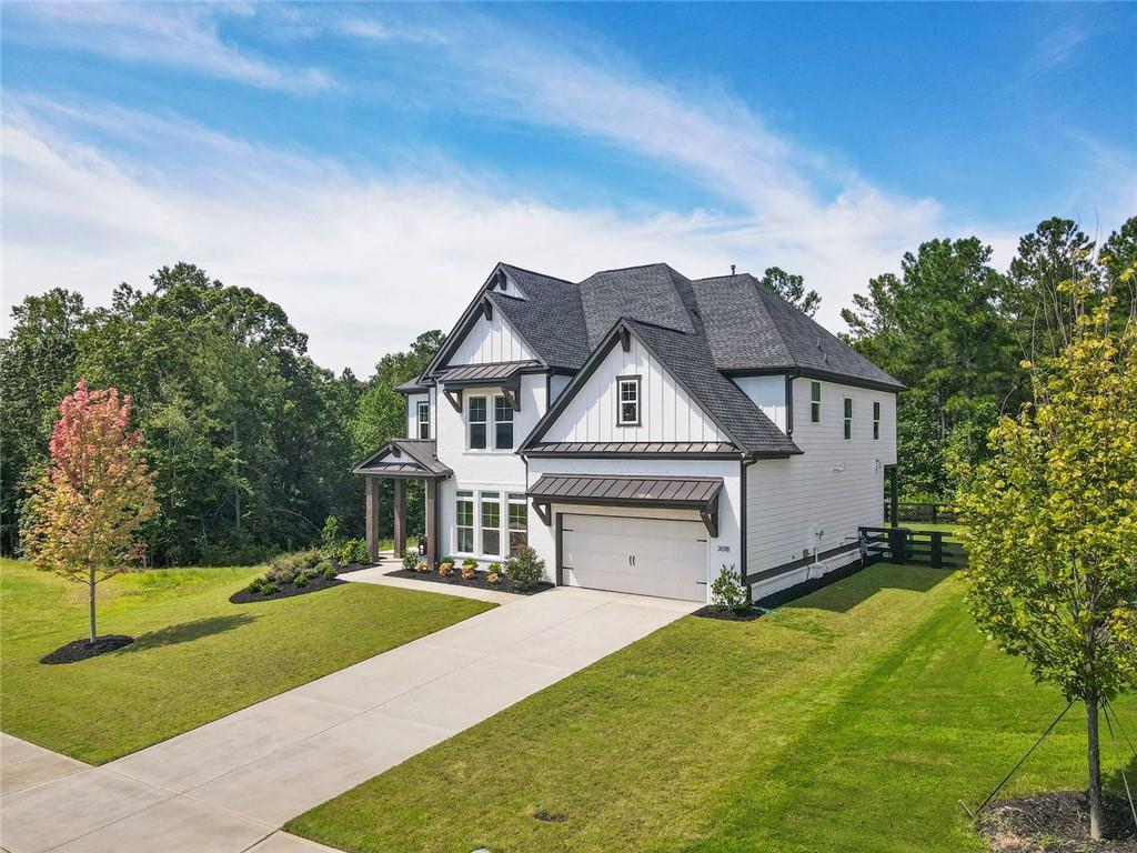 Situated just beyond the Milton line, this beautifully upgraded home combines timeless style with everyday functionality. A dramatic two-story great room anchors the open floor plan, which also includes a private office with custom double doors, formal dining room, and a gourmet kitchen with custom cabinetry, oversized island, and premium appliances.
The walk-out backyard is fully fenced and professionally landscaped.
Upstairs, the primary suite offers a spacious retreat with custom closet and a fully renovated bath boasting dual vanities, soaking tub, and upgraded shower. Additional highlights include custom built-ins, a thoughtfully designed mudroom, upgraded hardwood floors throughout, and a beautifully updated first-floor full bath.
Blending pastoral charm with modern convenience, this residence offers a rare opportunity to enjoy refined living just minutes from Atlanta National Country Club, Milton, Alpharetta, and Woodstock’s best amenities.