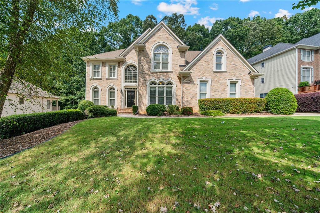 Original owners are ready to pass their well maintained and stunning John Wieland home to the next lucky owners! Welcome home to the Creekside community known for its unbeatable location, top Forsyth County Schools, shopping, dining and quick access to GA 400-all while tucked away in a peaceful neighborhood setting! This home sits on a generous sized lot with mature trees, offering both privacy and curb appeal. Inside you will find a floor plan that checks all the boxes! Off the 2-story foyer you will find a bedroom on main that makes a great office or provides a first floor guest room along with a well appointed half bath. On the other side of the foyer there is a lovely sitting room that adjoins a very spacious dining room. The stunning family room will certainly grab your attention with its 2-story stacked stone fireplace and custom built-in accent bookcase wall. This room is drenched in natural light from your private wooded backyard oasis! And if you spend anytime in the kitchen, get ready to fall in love with this HUGE open concept eat-in kitchen! There is also a wonderful breakfast nook for those everyday meals! Upstairs you will find an expansive master suite that is a real highlight of this home! Featuring a bonus room that could be a nursery, office, exercise room or the closet of your DREAMS! The spa-like master bath offers his and her closets, separate vanities and enough space to host a party! It's no wonder why John Wieland is quite well-known for his master bathrooms! The additional 3 bedrooms are all very generously sized and there is a Jack and Jill bath as well as another full secondary bath. Last but not least, you have even more house in your finished basement! Two oversized rooms in the main area give you so much space for entertaining or gathering. There is great finished room that could be an office or guest room as well as a full bath! This is all that extra space your family needs! This home is READY for you so get your showing booked while it is still available!
In Creekside, you'll find more than just a house-you'll find a community where neighbors take pride in their homes, lots are larger than most in the area and treelined streets create a welcoming place you'll love coming home too! Don't miss the opportunity to make this exceptional home yours TODAY!!