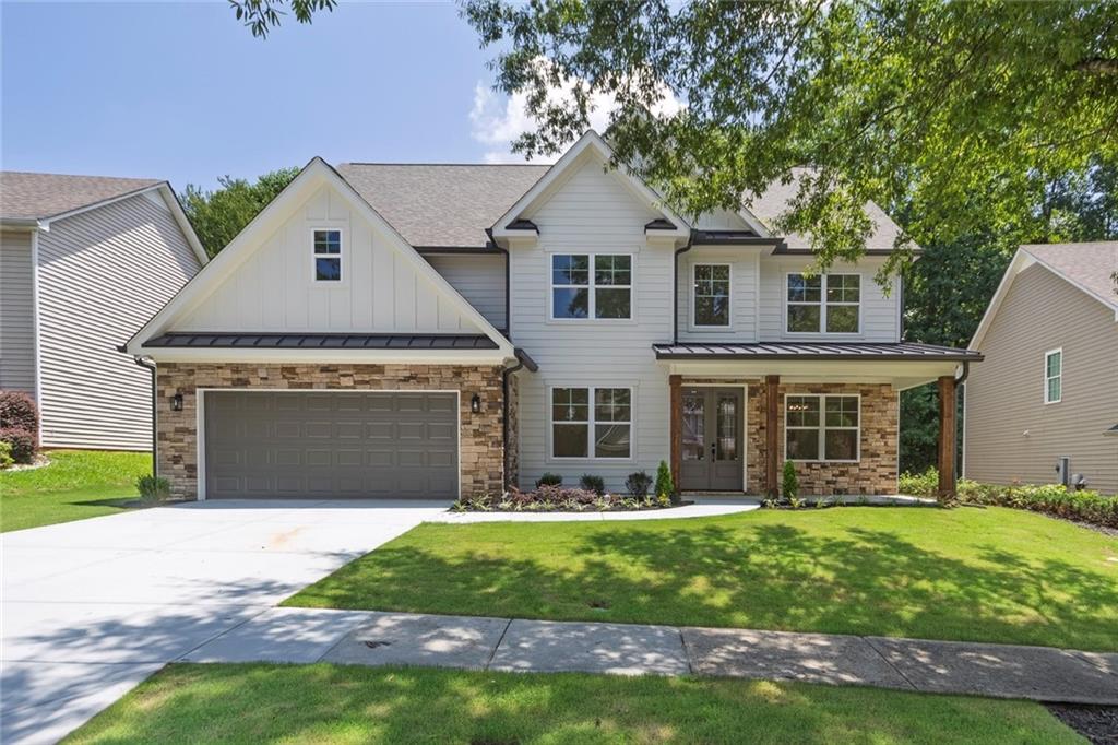 Stunning New Construction Home in Loganville’s desirable Watson Grove subdivision, known for its excellent school district and welcoming community. This beautifully crafted 5 bed / 4 bath Smart Home offers an open-concept layout designed for modern living. Throughout the home, you’ll find gorgeous white oak engineered wood floors, adding warmth and elegance to every room. The main floor features beamed ceilings, a 60” electric fireplace with built-in WiFi set in a breathtaking floor to ceiling stone wall, a custom bar with built in wine cooler, a mudroom, and a spacious guest bedroom with full bath access, perfect for guests or a home office. The gourmet kitchen includes quartz countertops, custom cabinets with under-cabinet lighting, stainless steel appliances including a 36” electric range, a large 8’ long center island with pop-up outlets, microwave drawer, and a spacious pantry all open to the family room. Upstairs, you’ll find a luxurious oversized primary suite complete with a spa-inspired bathroom and generous walk-in closet. Three additional secondary bedrooms, a full bath, and laundry room with a sink and cabinets for additional storage complete the upper level. Enjoy outdoor living with a covered front porch and a spacious back porch overlooking the landscaped yard with fire pit, fresh sod and wooded views. Smart Home upgrades include a central structured wiring closet, RJ45 Ethernet ports throughout, USB outlets, WiFi thermostats, a circulation pump that provides instant hot water anywhere in the house, EV charger available, and Pex plumbing throughout. Termite control for 1 year with Arrow Exterminators. Located in a quiet neighborhood with easy access to schools, parks, shopping, and dining. Nearby attractions include Vines Botanical Gardens, Tribble Mill Park, Fort Yargo State Park, Coolray Field, Gas South Arena, and the Mall of Georgia, offering endless options for recreation, entertainment, and shopping. Don’t miss this incredible opportunity to own a brand-new home in a prime location.