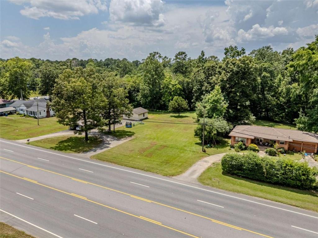 The Property consists of 1.02 acres of land situated on Martha Berry Highway, directly across from Rhinehart Equipment Company, and between street addresses 3569 and 3589 Martha Berry Hwy. According to GPS mapping, the property is approximately 0.5 miles north of the Food Lion at 3365 Martha Berry Highway, within the city limits of Rome, Georgia. The land offers a mix of open and wooded areas, providing natural privacy, buildable space, and versatile topography. The parcel is currently zoned C-C (Community Commercial) under Floyd County zoning regulations, allowing for a wide range of uses including retail, office, service-based businesses, or a live/work hybrid. This property is located within a highly trafficked commercial corridor, offering outstanding visibility, accessibility, and proximity to major educational, recreational, medical, and commercial institutions including: Berry College, Rome Tennis Center at Berry College, Local and regional shopping centers, Elementary, Middle and High schools, Floyd Medical Center and Redmond Hospital