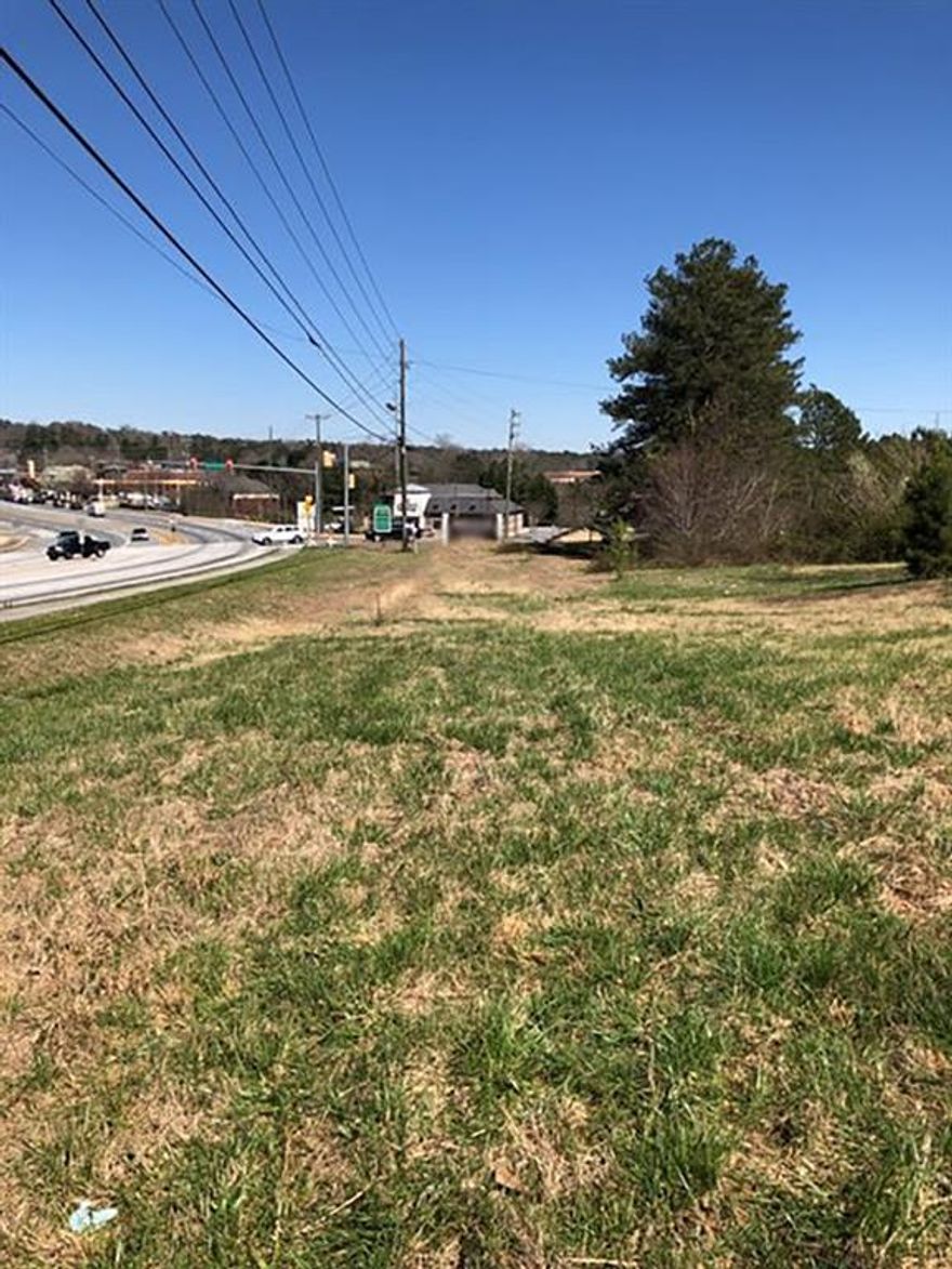 The potential and possibilities of this property are ENDLESS!!  Conveniently located and a prime location for development. Area of rapid growth and with high traffic counts. The house and out building are considered "tear down" in terms of use.