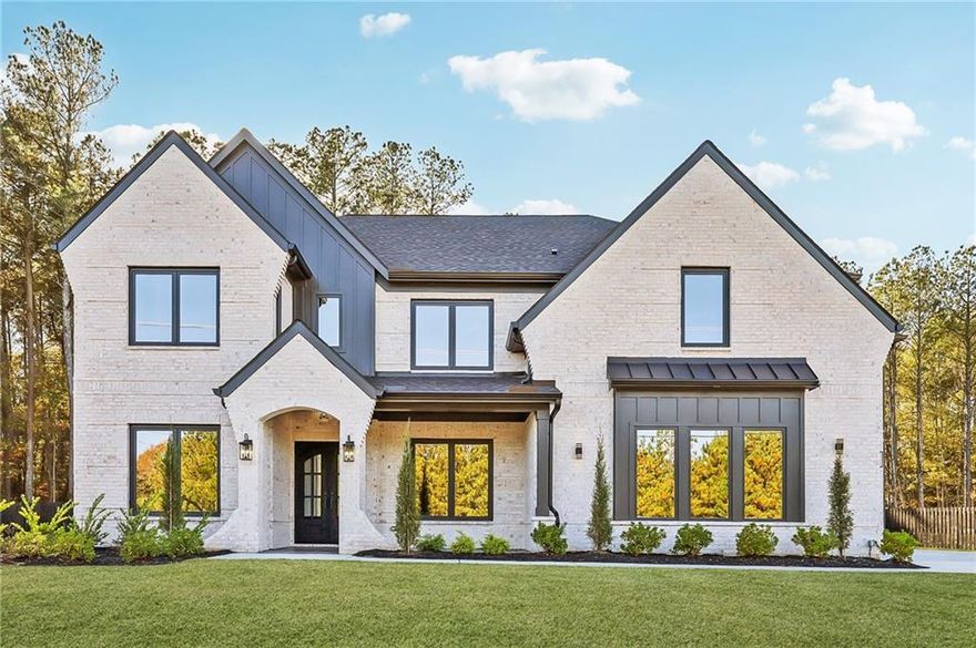 Custom new construction on a privately gated and fully fenced 0.72-acre lot, this stunning 4 bedroom 4.5 bathroom home also includes an additional flex room perfect for a 5th bedroom. The estate blends luxury, privacy, and thoughtful design in every detail. From the moment you enter through the gate, the long driveway and beautifully landscaped exterior set the tone for the exceptional craftsmanship found throughout the home. Inside, soaring 10-foot ceilings and a spacious walk-in foyer create an immediate sense of openness and elegance. Just off the foyer, an impressive office with double glass metal doors and a formal dining room offer refined spaces for work and entertaining. The heart of the home is the gourmet chef’s kitchen, showcasing a large double quartz waterfall island, premium top of the line appliances, a 48-inch gas range, pot filler, and wine cooler. The kitchen seamlessly flows into the expansive living room, creating the perfect layout for gatherings and everyday living. On the main level, one of two private primary suites offers a retreat-like setting with a luxury en suite and its own secondary laundry room for added convenience. Through the sliding glass doors off the kitchen, step onto a large covered back patio featuring a cozy fireplace and peaceful views of the private, level backyard, ideal for a future pool, outdoor kitchen, or personal oasis. Upstairs, the home continues to impress with a spacious secondary living room complete with a fireplace, perfect for media, relaxation, or additional entertaining space. Two generously sized secondary bedrooms with access to well-appointed bathroom, accompany a flexible bonus room ideal for use as a fifth bedroom, complete with its own private en suite. An oversized second laundry room with ample storage adds functionality to the upper level. The true highlight upstairs is the second primary suite, an elegant retreat featuring its own fireplace, sitting room, and a spa-inspired en suite with a large soaking tub, oversized frameless shower, and an expansive custom closet designed for luxury and organization. Additional high-end features include noise canceling insulation, custom imported European windows, energy efficient foam insulation, and a tankless hot water heater. Full front and back irrigation ensures the property remains beautifully maintained year-round. The expansive lot also offers ample space on the left side of the property to add an additional garage, workshop, or detached building, providing endless possibilities for customization. This exceptional home combines modern luxury, premium finishes, and unmatched privacy, all while being located just minutes from Highway 316, shopping, dining, and everyday conveniences.