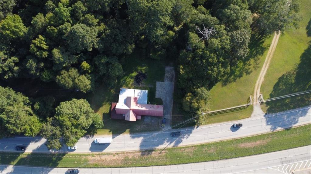 PRIME 5+ ACRE OPPORTUNITY This property offers 5+ acres of land with 403 feet of road frontage directly on Highway 78, providing excellent visibility and accessibility. While there is an existing structure on-site, it is a total tear-down, making this an ideal blank canvas for your vision. Currently zoned residential, the property holds strong potential for commercial use with the right approvals, making it perfect for investors, developers, or business owners seeking a high-traffic location. Don't miss this rare chance to own a large tract of land in a prime growth corridor with endless possibilities.