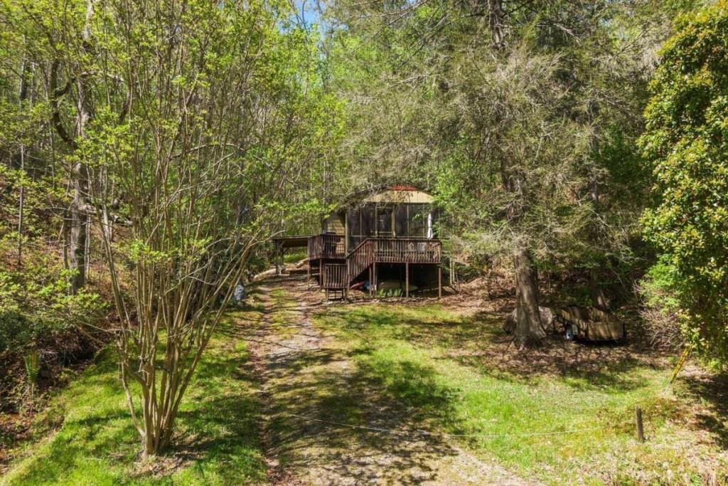 Lower Toccoa Riverfront cabin with endless potential for expansion -- they don't make them like this anymore! This quaint cottage blend cabin is complete with a full kitchen, large living room with French doors to an expansive screened-in porch and river views, one large bedroom suite and an additional office/den room. With a babbling brook on the backside of the property and a gorgeous lush meadow on the front side walking out to the flat and ready to use riverfront portion, this cabin is affordable and one of a kind. Call today!