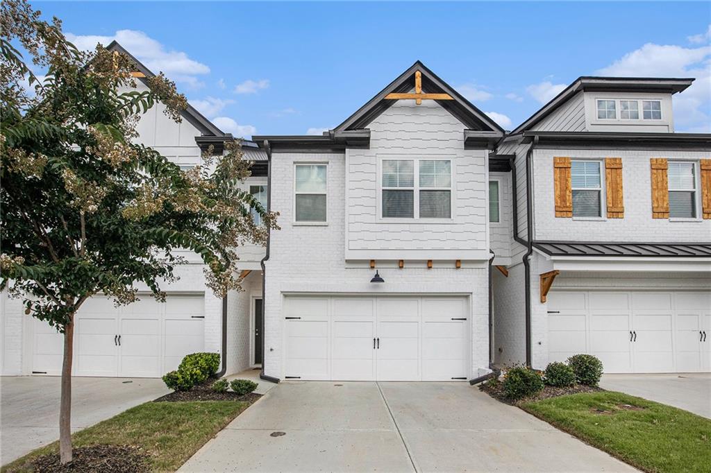 VACANT QUICK CLOSE 62 Garrison Drive, a move-in-ready, modern townhouse offering low-maintenance living in a prime Winder location, just minutes from Hwy 85. This 3-bedroom, 2.5-bath home features an open-concept layout with luxury vinyl plank flooring, soaring ceilings, and an inviting electric fireplace in the spacious living room. The gourmet kitchen showcases painted cabinetry, a large quartz-topped island, stainless steel appliances, and elegant pendant lighting, ideal for both everyday meals and entertaining. Upstairs, you'll find a versatile loft-style second living area and a spacious, light-filled primary suite with two additional bedrooms. Enjoy a private, fenced backyard with a patio perfect for grilling or relaxing. HOA includes exterior maintenance, pest control, termite bond, and swim amenities. No rental restrictions make this a great investment opportunity as well. Don’t miss this well-appointed townhome that blends modern comfort with convenience!