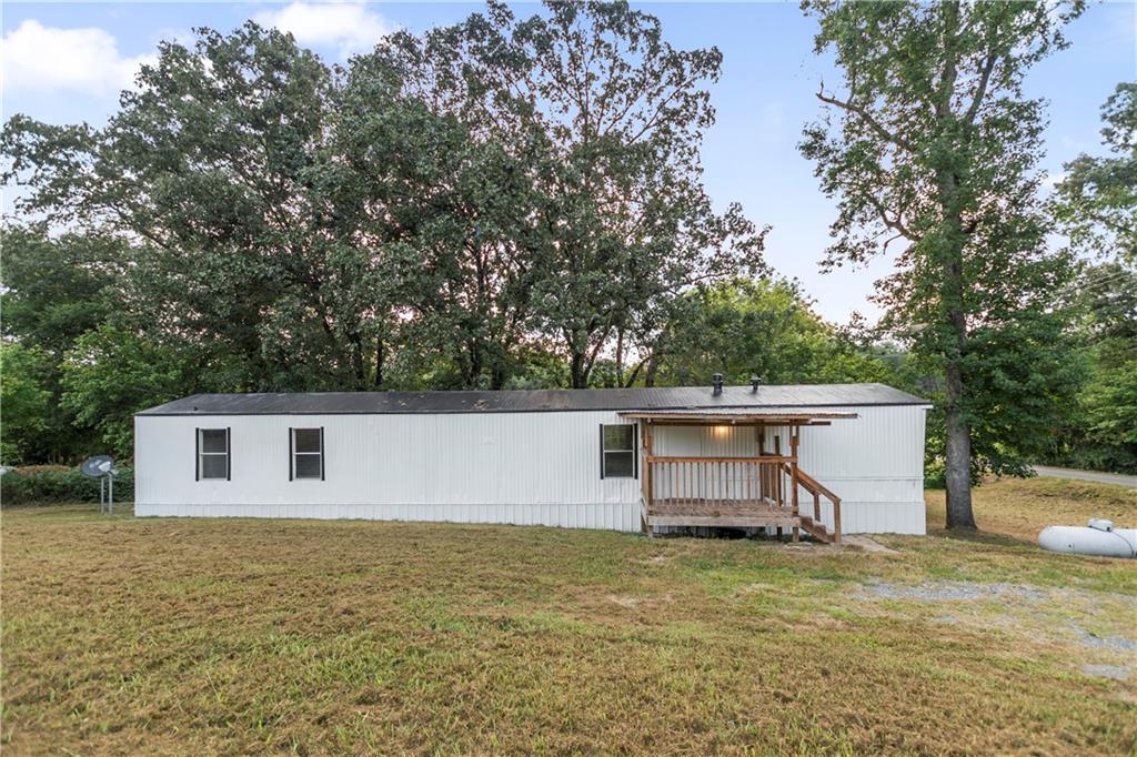 Explore this welcoming 2-bedroom, 2-bathroom manufactured home situated on a generous and attractive corner lot. Recently underpinned and anchored to a permanent foundation, verified by a Structural Engineer Report, the home has been fully renovated. The updates include fresh interior and exterior paint, covering even the roof. Enjoy the newly constructed back deck or the cozy front porch. The kitchen features an island and ample cabinet space, opening to a spacious den on one side and a dining area on the other, complete with built-in cabinets. Both bedrooms are spacious. The home features brand-new, fashionable LVP flooring throughout. Each bathroom has been updated with new toilets, modern vanities, and tiled showers. This home, offered at an appealing price, is certainly a must-see! And don't forget that it qualifies for Conventional, FHA and VA lending!