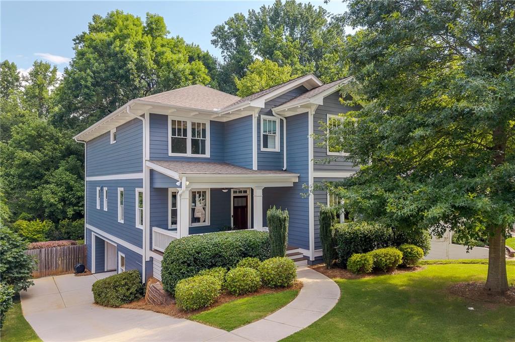 This newly constructed Craftsman is a must-see, offering exceptional living and entertaining spaces. Tucked away on a quiet dead-end street leading into Dearborn Park, this home welcomes you with an inviting front porch that instantly feels like home. Step inside to discover a beautifully refreshed interior featuring updated light fixtures and fresh paint throughout. The open-concept main level is designed for both style and functionality, boasting a chef’s kitchen with floor-to-ceiling cabinetry, top-of-the-line appliances, a walk-in pantry, and a formal dining area. A spacious living room flows seamlessly to the covered patio, where you can relax while overlooking the private, manicured yard. A full bedroom and bath on the main level provide flexibility for guests or a home office. Upstairs, wide and inviting stairs lead to four generously sized bedrooms, including a serene primary suite with two walk-in closets and a spa-like bath. The finished lower level is the perfect retreat, offering a media space, bonus room, and full bath. The two-car carport can easily be converted into a full garage and includes conditioned storage. Located in the coveted Decatur public school district, this home is just minutes from Decatur Square, Oakhurst Village, McKoy Park, and more.