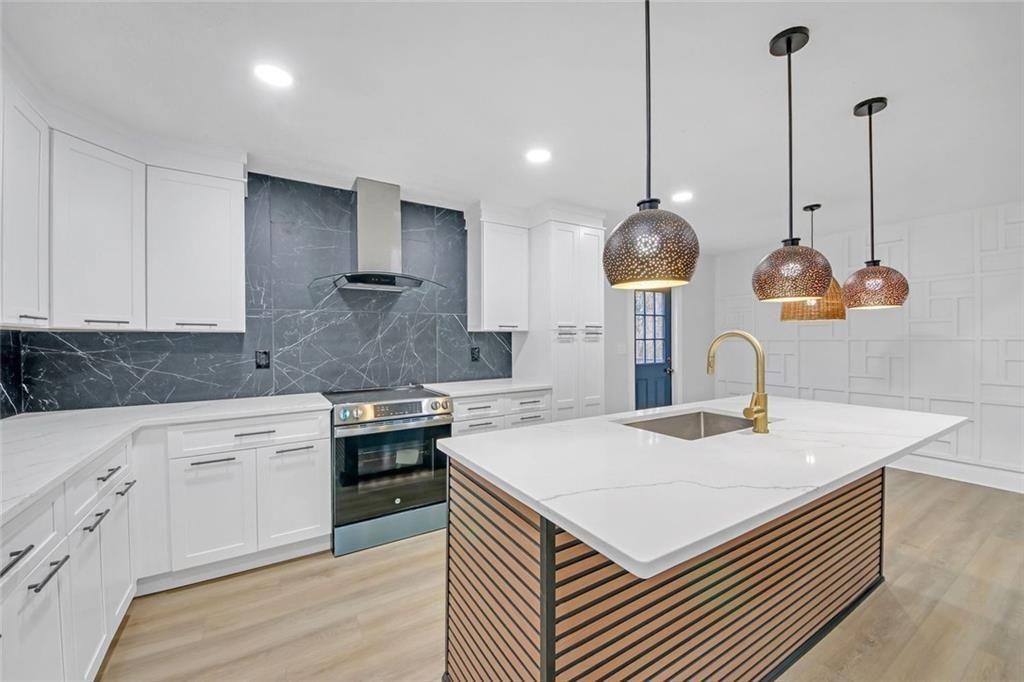 Beautifully Renovated 3-Bedroom Home, LOCATED approximately 1 MILE from Downtown Woodstock with Finished Basement, Designer Upgrades & NO HOA. Welcome to this beautiful home, where modern elegance meets comfort on a quiet cul-de-sac. Step onto the expansive new front deck and enter the inviting great room, featuring a cathedral-beamed ceiling and an open layout that seamlessly connects to the bright, newly designed kitchen. The kitchen is a chef's dream, boasting new white cabinetry, quartz countertops, a stylish backsplash, a large island, and an eat-in dining area with access to the spacious back deck overlooking the backyard -perfect for gatherings and entertaining. Thoughtful upgrades throughout include custom wall trim and new wood flooring, adding warmth and character to the home. The primary suite offers a finished walk-in closet and a spa-like en-suite bathroom with dual vanities and a walk-in shower with dual shower heads. Two additional spacious bedrooms share a newly updated bathroom featuring double vanities and a quartz shower/tub combo. The finished basement provides extra living space, including a large family room and an additional room with a closet, ideal for a home office, gym, or guest quarters. Easy access to the two car garage with extra storage. Many upgrades include new roof, windows, front deck with supports, flooring, light fixtures and more. This move-in-ready home is a must-see-schedule your showing today!