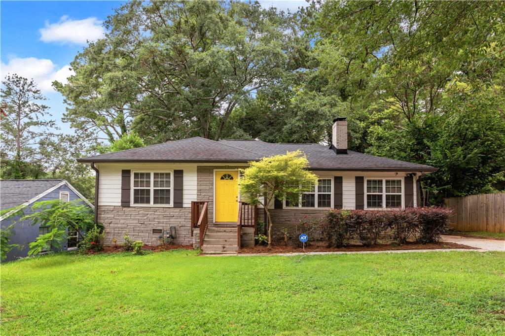 With its cheerful yellow door and inviting curb appeal, this thoughtfully updated bungalow delivers style, function, and versatility in one smart package. Step inside to a light-filled living space anchored by a charming brick fireplace and hardwood floors that flow throughout. The layout connects the living area, dining space, and kitchen with ease, making both daily routines and entertaining feel natural and connected.
The kitchen offers plenty of workspace, crisp cabinetry, stainless steel appliances, and a large peninsula with seating, ideal for casual meals and ensuring the cook is never left alone and always connected. Just beyond the dining area leads, to a the screened-in side porch which adds another layer of functionality, perfect for morning coffee, quiet reading, or bug-free evenings outdoors and a deck overlooking the backyard, extending your living space outdoors. A flexible bonus room off the main living area offers endless possibilities as a home office, guest space, or creative studio. Two large bedrooms offer comfortable arrangement and share a renovated central hall bath.
Outside, a long driveway provides ample parking, and the spacious yard is framed by mature trees for a sense of privacy. This home blends comfort and utility in a location with quick access to the city, airport, and neighborhood amenities such Rosie's Cafe (perfect for coffee, breakfast, brunch or lunch) and Brookdale Park. The park has the convenience of access to tennis and basketball courts, a fully equipped playground, and a flowing creek covered by walkable bridges.