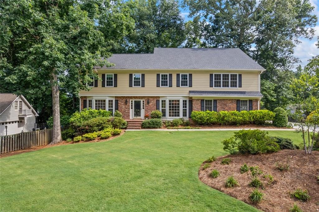 Rare find in the heart of Dunwoody, walk to Dunwoody Village in minutes! This meticulously maintained home has been expanded/renovated to include a spacious master suite, a home office/gym, and a huge open concept kitchen/family room area. A private back staircase leads you to the primary suite which includes a huge walk in closet, custom cedar closet, spacious en suite bath with soaking tub and separate shower. You will also find a bonus room attached, the perfect space for a home office, gym, or nursery. Upstairs has four additional oversized bedrooms including a second master suite. Beautifully appointed bathrooms have been recently renovated with gorgeous marble/tile finishes. The main level of this home has been expanded to include an open concept kitchen/family room, finished with a stunning wall of windows allowing in tons of natural light. Beautifully appointed kitchen with SS appliances, granite countertops, and massive island that is open to the family room. Cozy library with built in shelving/cabinetry and brick fireplace. The finished basement offers a huge space with a movie screen(included), a potential 6th bedroom with a finished walk in closet and full finished bath. An abundance of storage space! Beautiful sun room with custom ceiling leads to the back deck, a quiet spot for outdoor dining. Recent updates include brand new carpet and paint throughout, new landscaping & irrigation, renovated bathrooms and more. You'll find so many bonus items in this home including custom built ins, bay windows, pocket doors, an EV charging hook up in garage, three custom cedar closets, air filtration in HVAC system, new windows, etc.... Perfectly situated in the heart of Dunwoody, you'll find the Spruill Center for the Arts, Dunwoody Village, Brook Run Park, Dunwoody Nature Center and so much more within a mile or two from this house.